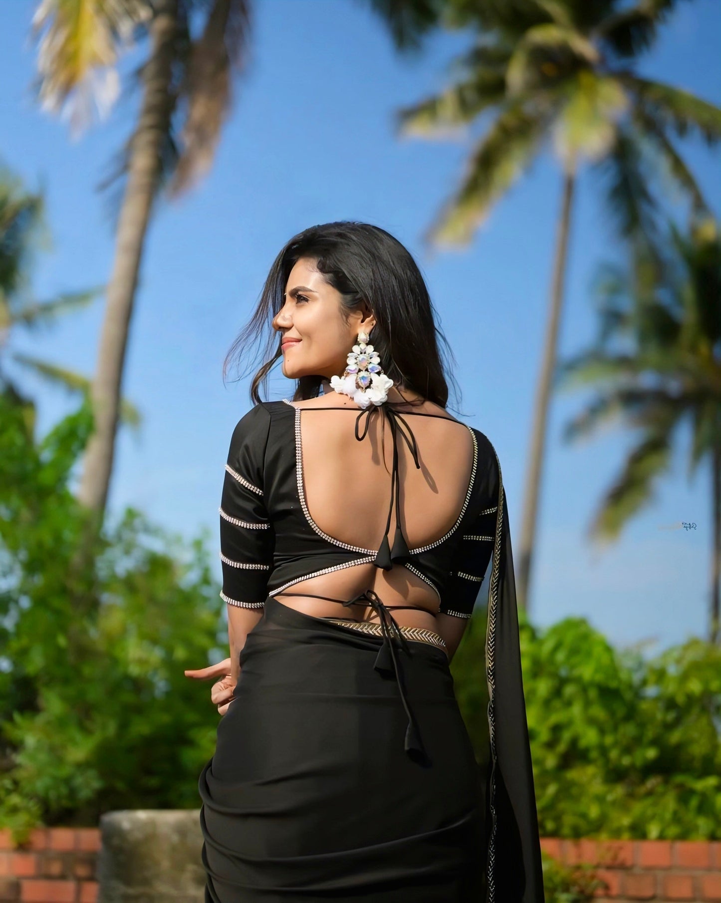 Elegant black deep-back blouse with double tie design and silver border, perfect for party and saree looks.