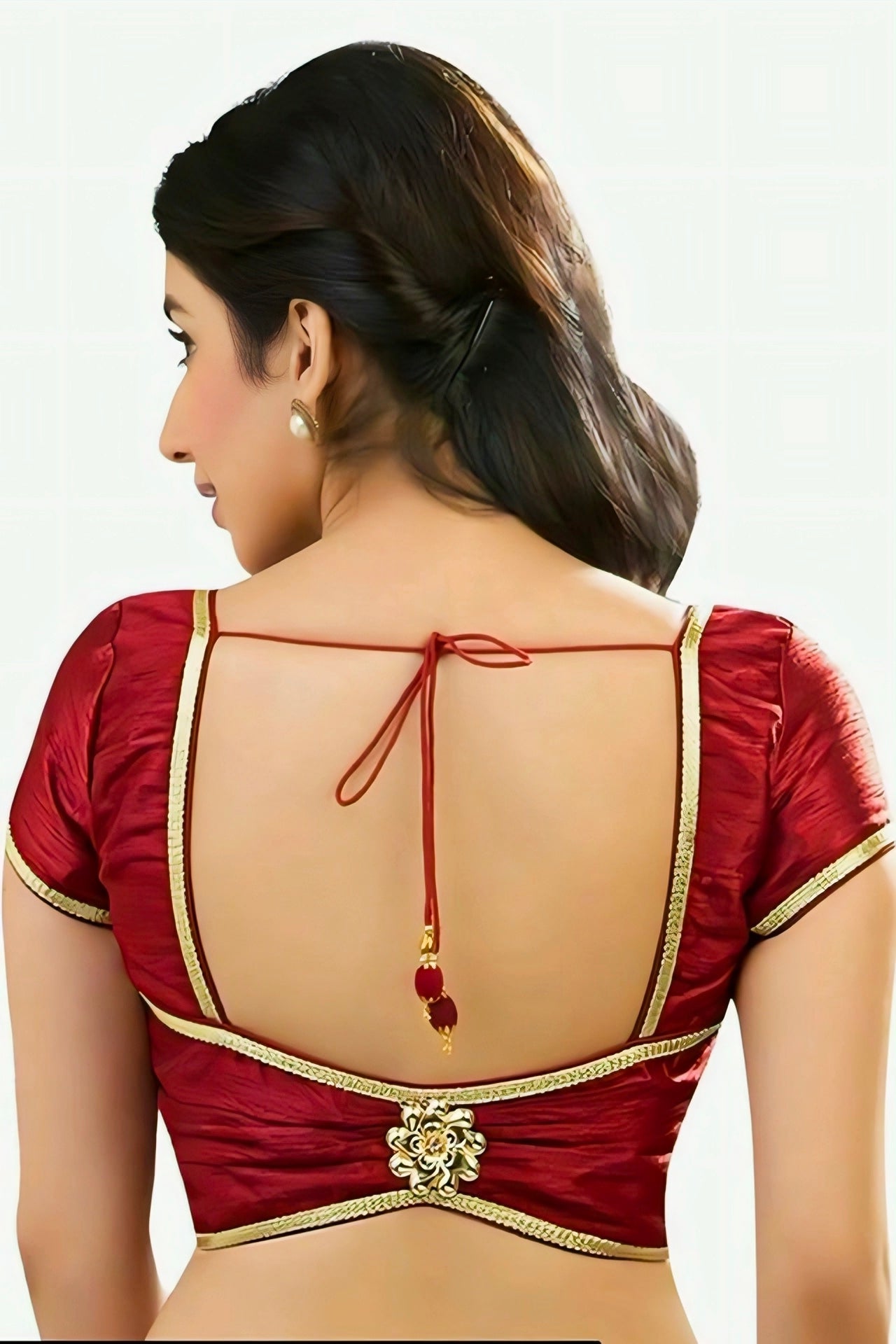 Elegant red silk blouse with golden lace border and deep U-cut back design featuring dori tie and floral motif.