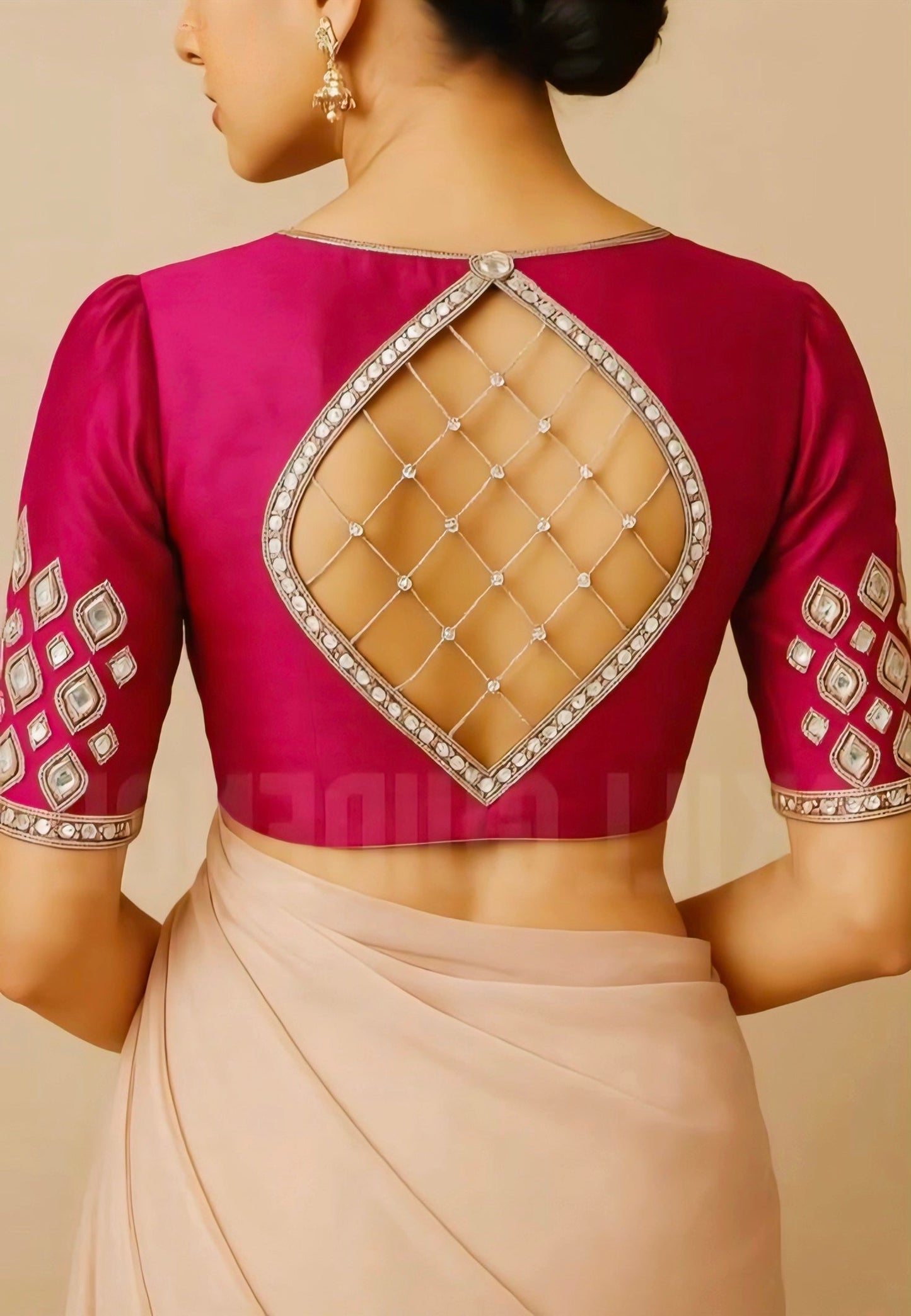 Magenta mirror work blouse with diamond-shaped back cut design and net detailing, perfect for festive and wedding saree looks.