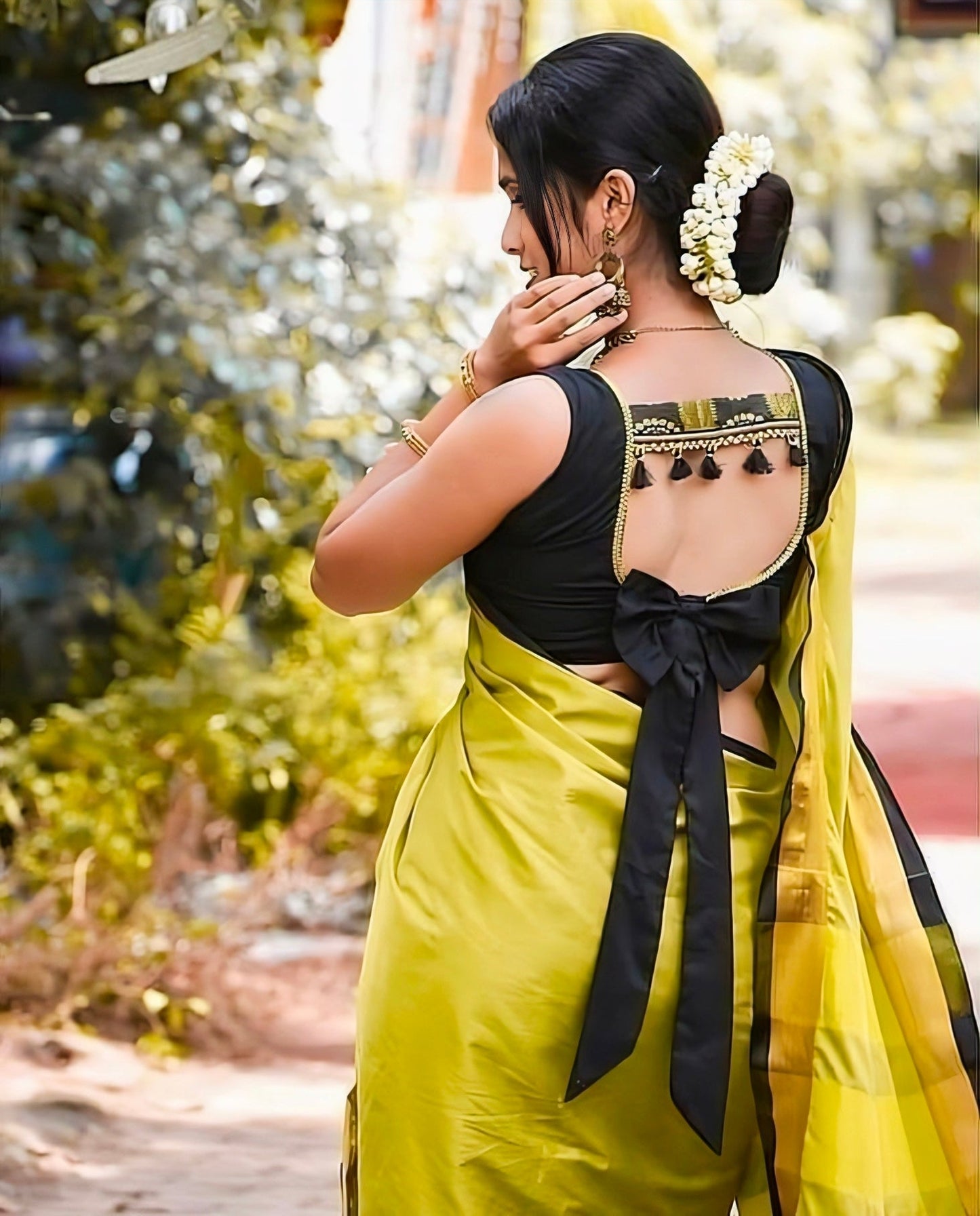 Black square back-neck blouse with tassels and large bow-tie design