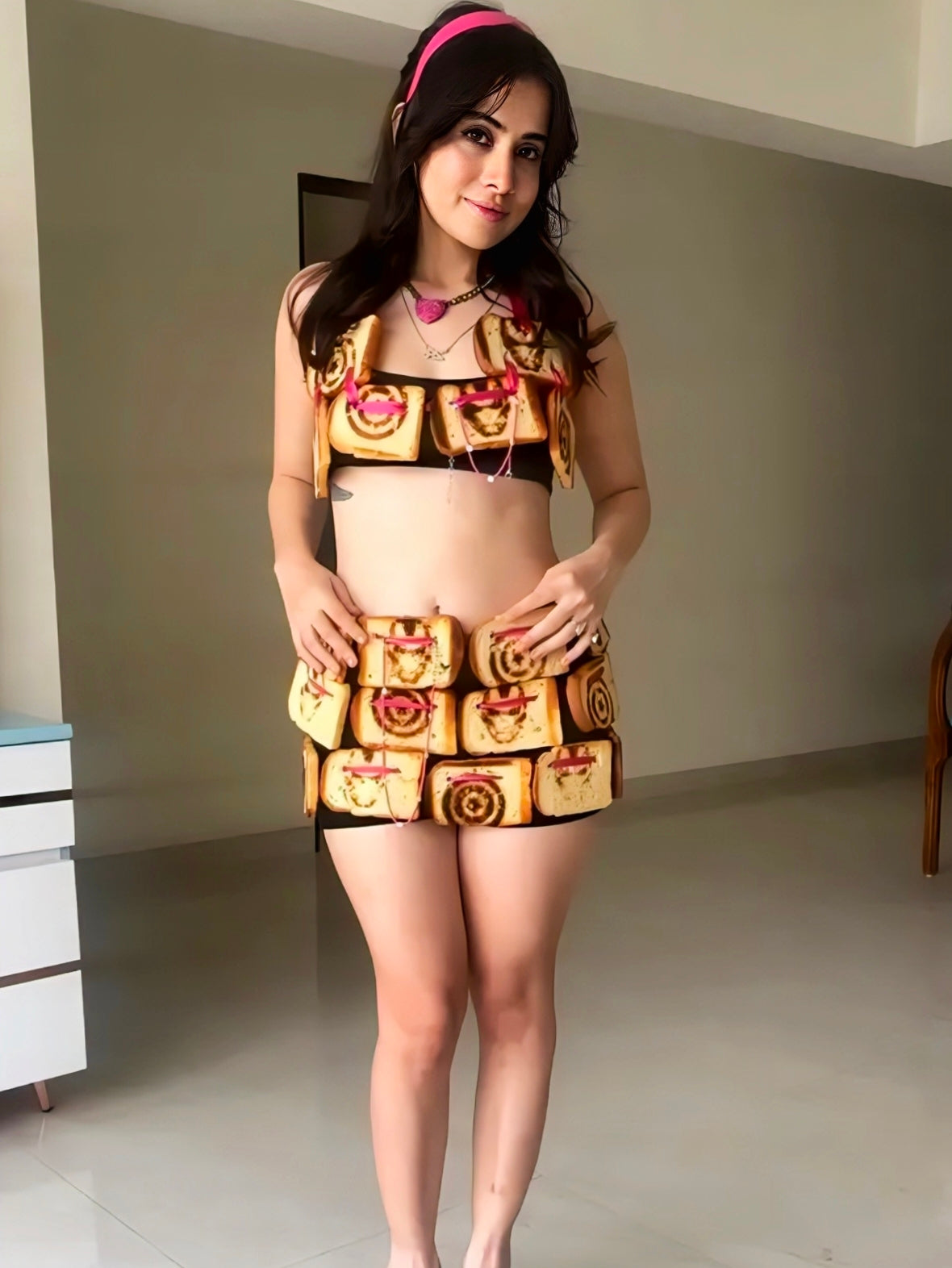 Bread-inspired two-piece outfit made from toasted slices styled with pink headband and heels for quirky fashion look