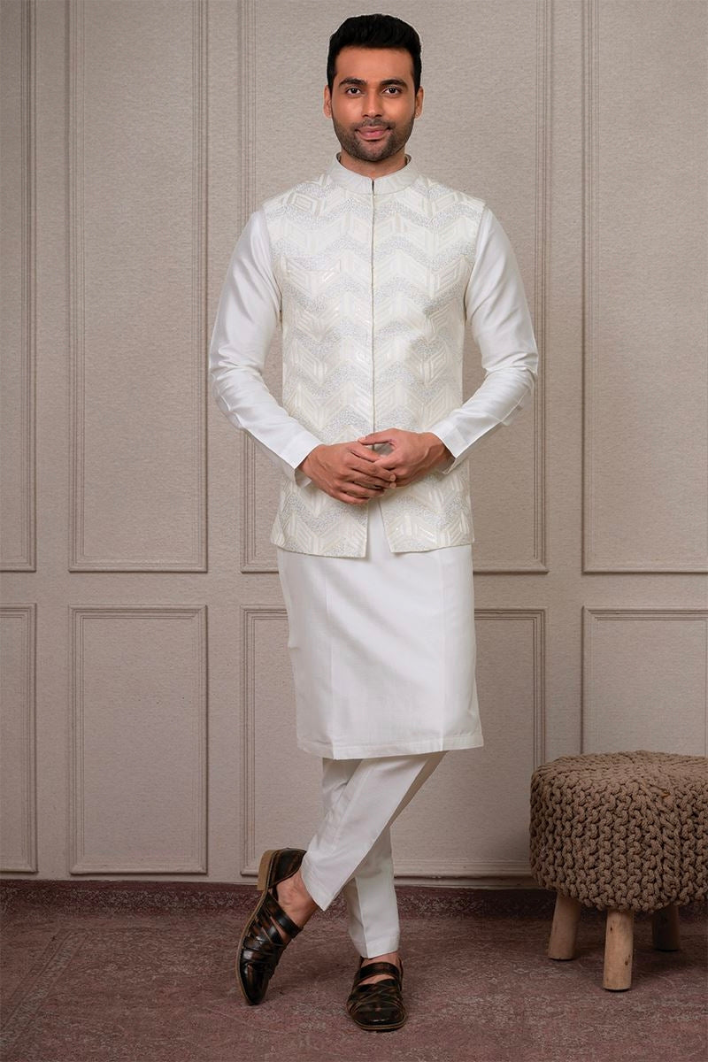 Engagement white dress for men with ivory embroidered Nehru jacket and white kurta churidar
