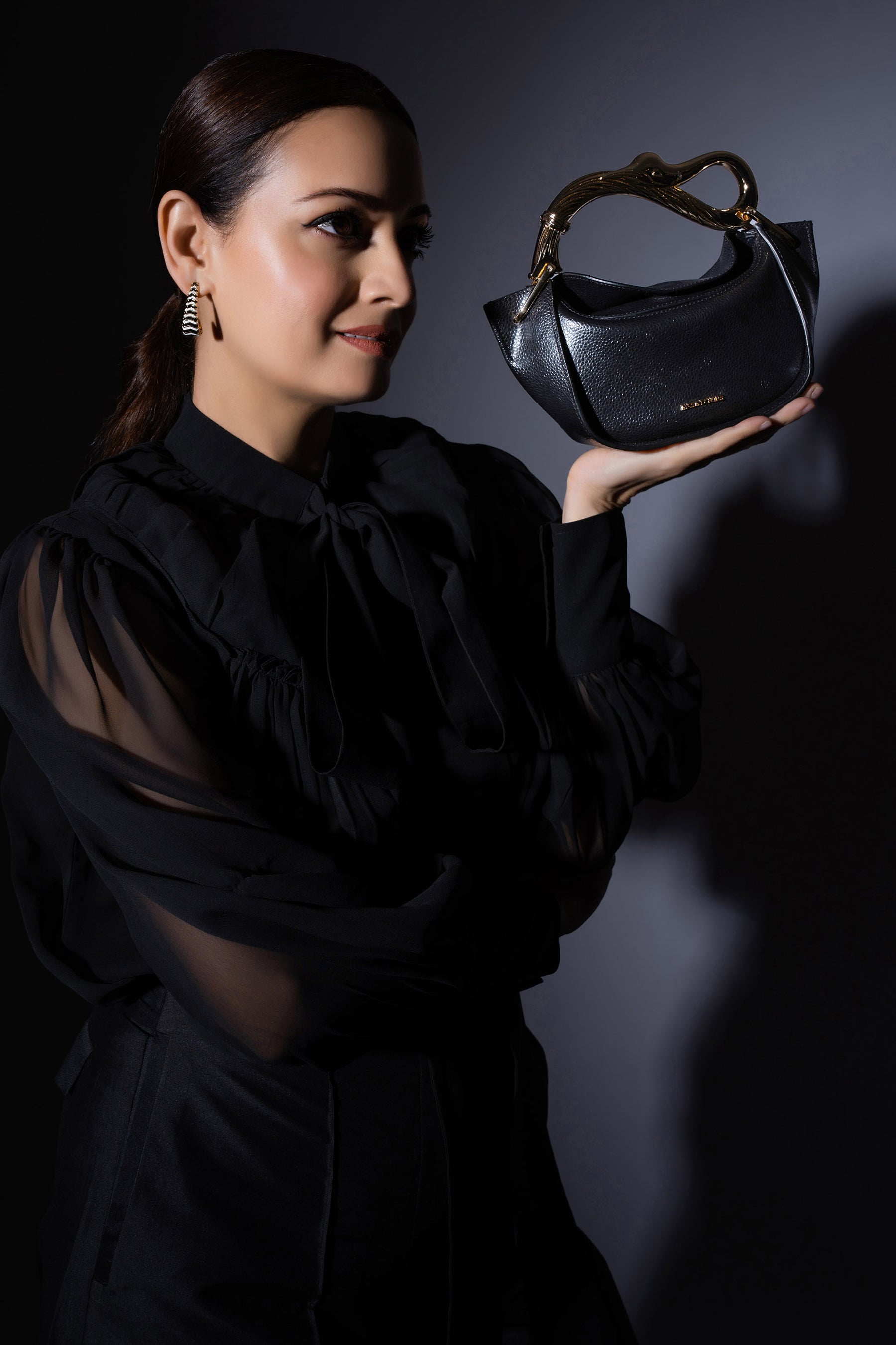 Dia Mirza carries our luxurious mini grab bag crafted from Mirum