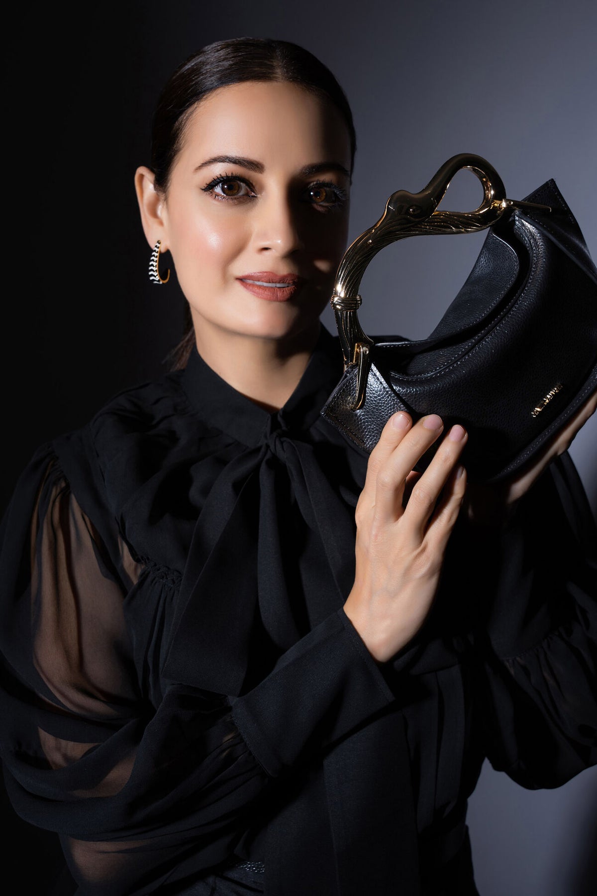 Dia Mirza carries our luxurious mini grab bag crafted from Mirum