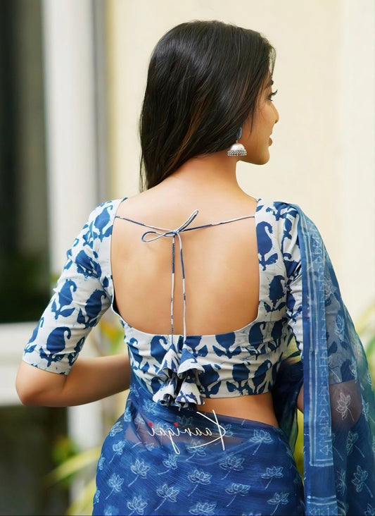 Elegant blue printed cotton blouse with open-back tie design and handcrafted tassels, perfect for saree styling.