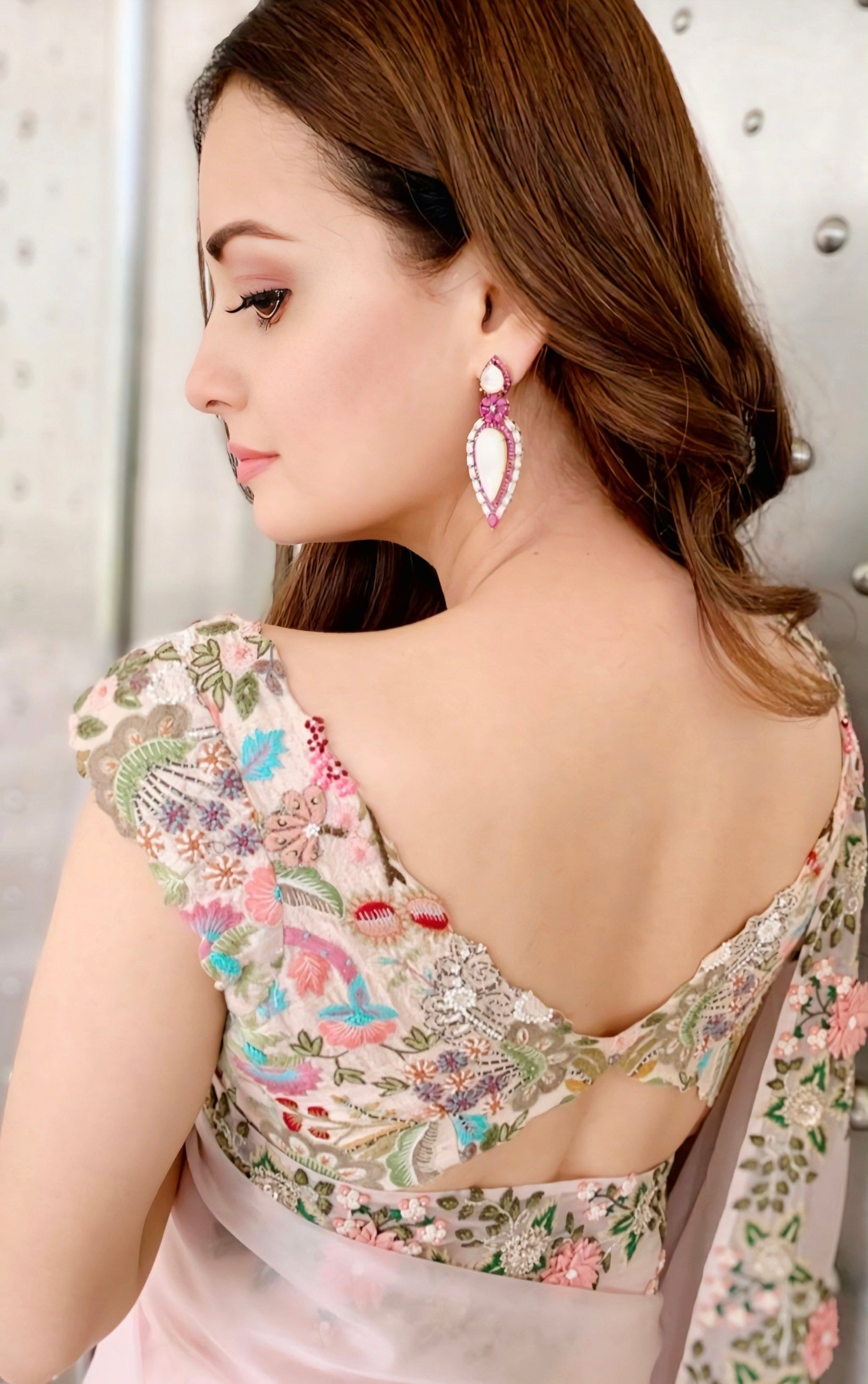 Floral embroidered blouse with deep back cut and scalloped border, ideal for wedding and festive sarees.