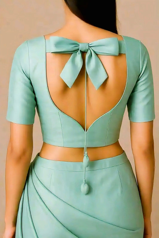 Mint green bow back blouse design with dori tie, ideal for festive and wedding saree outfits.