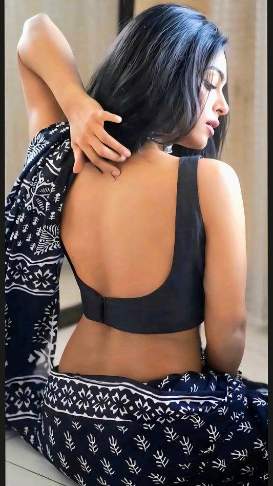 Minimalist deep U-back cotton blouse that defines elegance through simplicity. Pair it with a block print saree for a classy and timeless appeal.