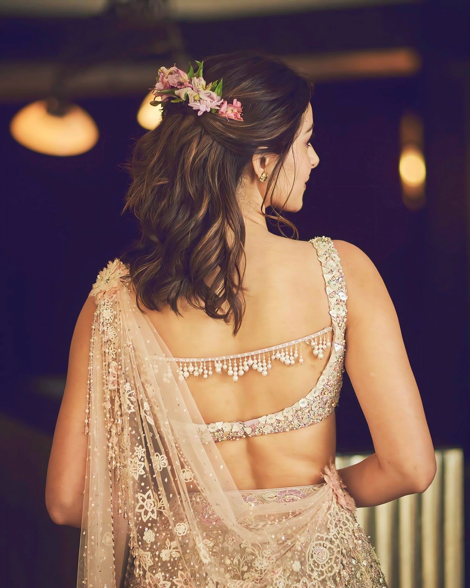 Ivory mirror work blouse with deep back design and pearl tassel detailing – celebrity-inspired ethnic fashion.