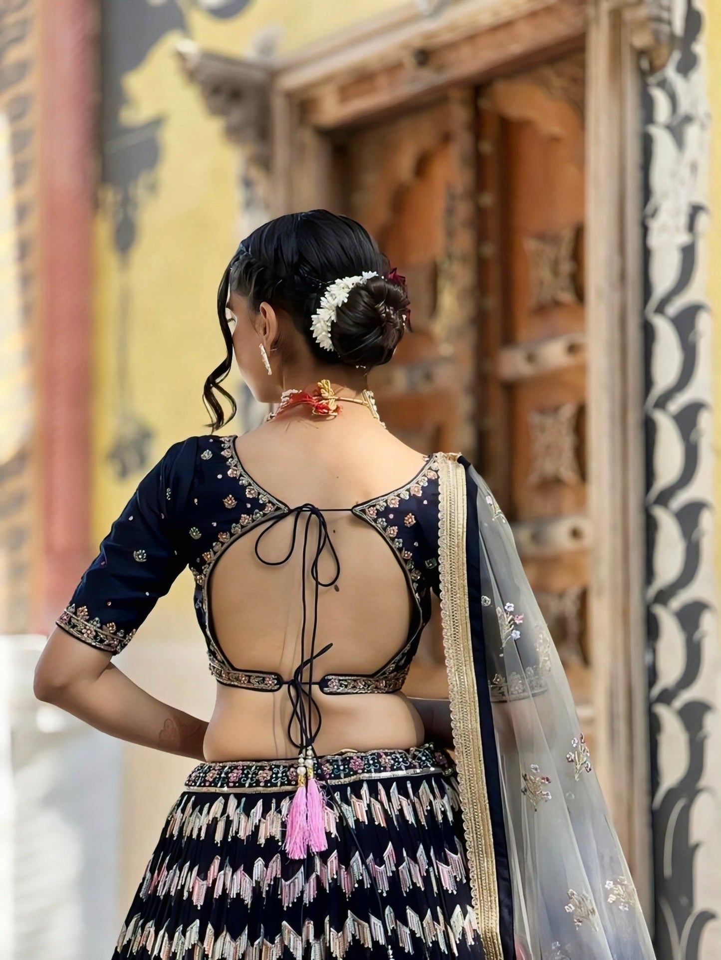 Trendy navy blue embroidered back-neck blouse design with dori tie and cutout pattern – blouse design inspiration.