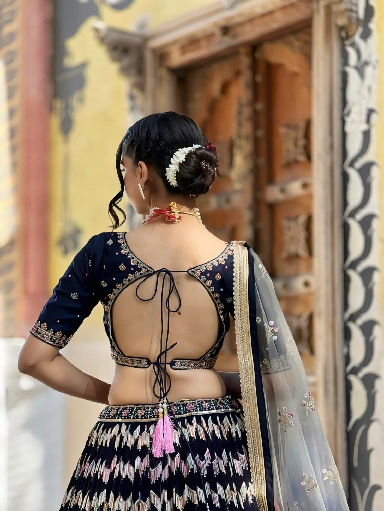 Trendy navy blue embroidered back-neck blouse design with dori tie and cutout pattern – blouse design inspiration.