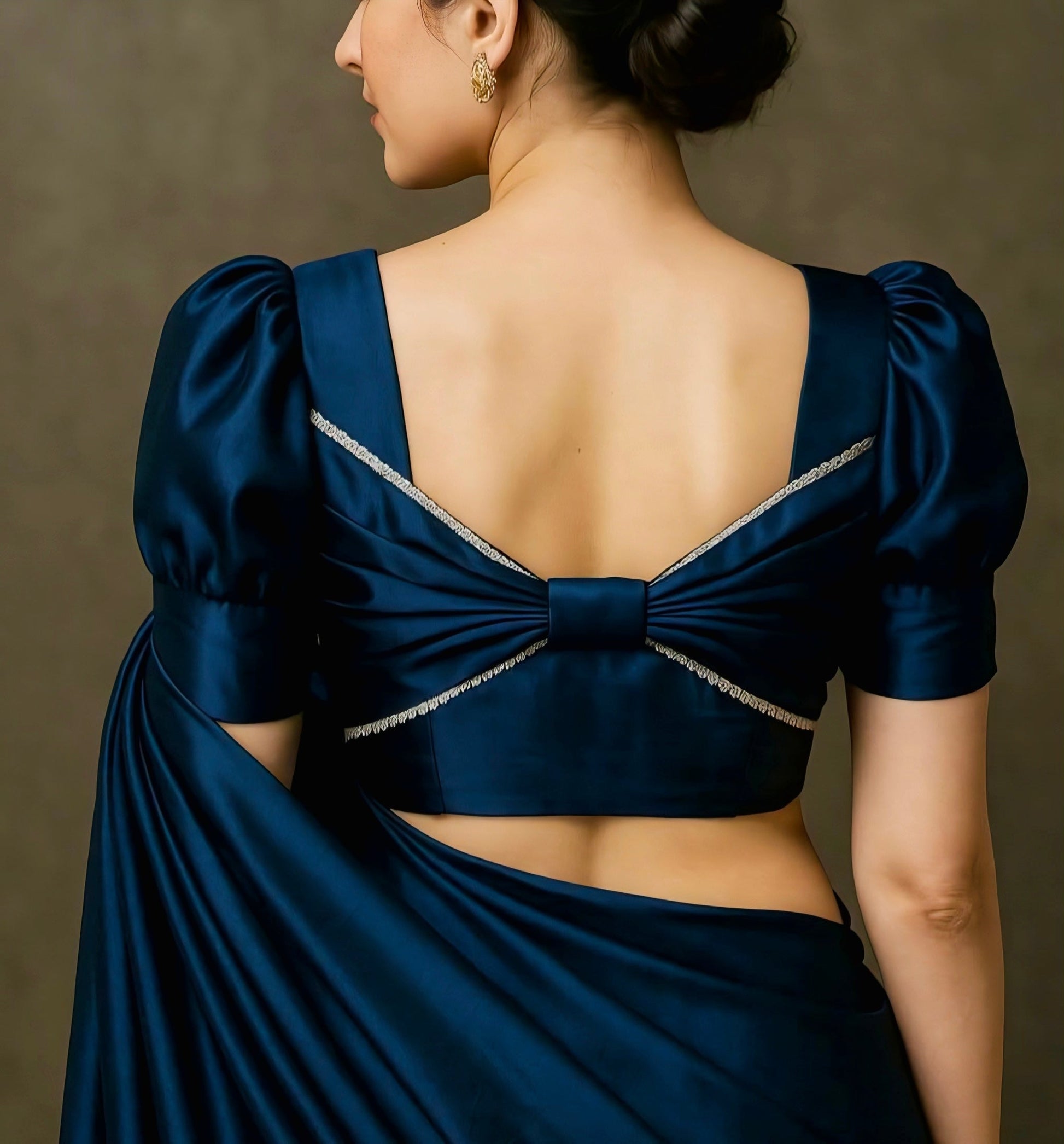 Navy blue satin blouse with square back neck, puff sleeves and bow-back design