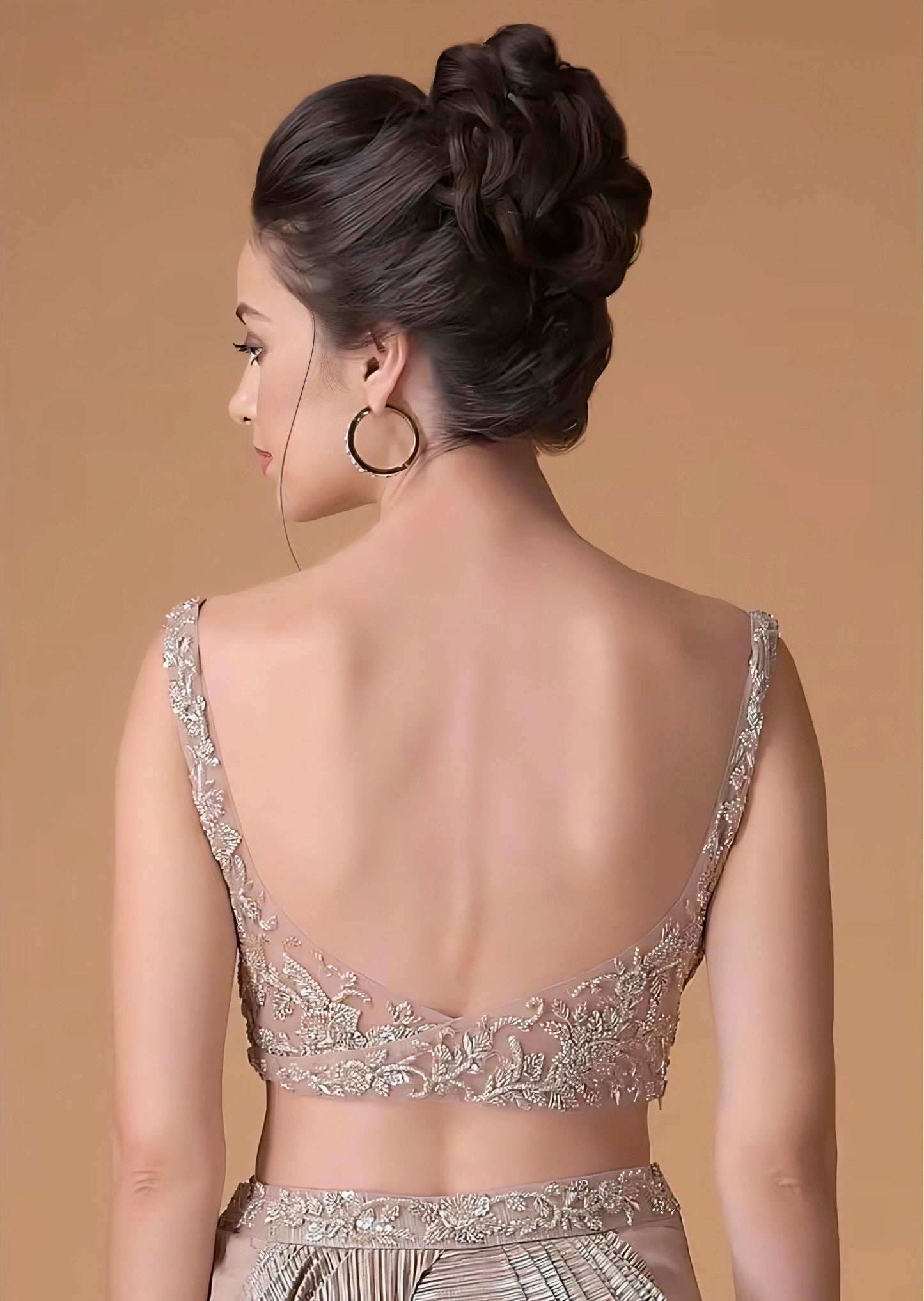 Deep V-back nude-gold blouse with sheer embroidered detailing – blouse back design inspiration.