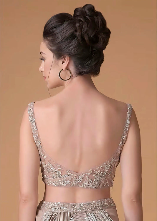 Deep V-back nude-gold blouse with sheer embroidered detailing – blouse back design inspiration.