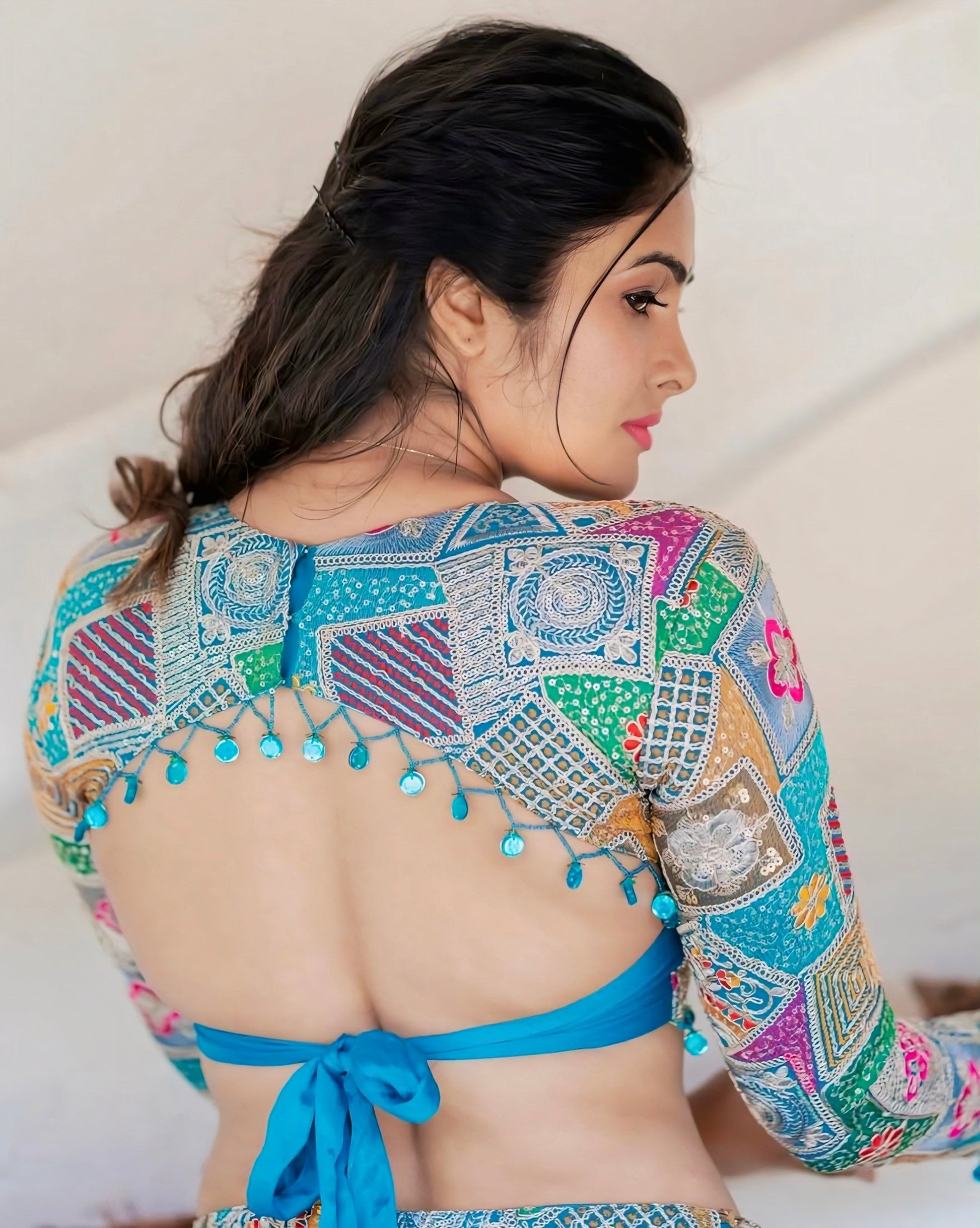 “Woman wearing a colorful embroidered backless blouse – Rimzim Fashion”