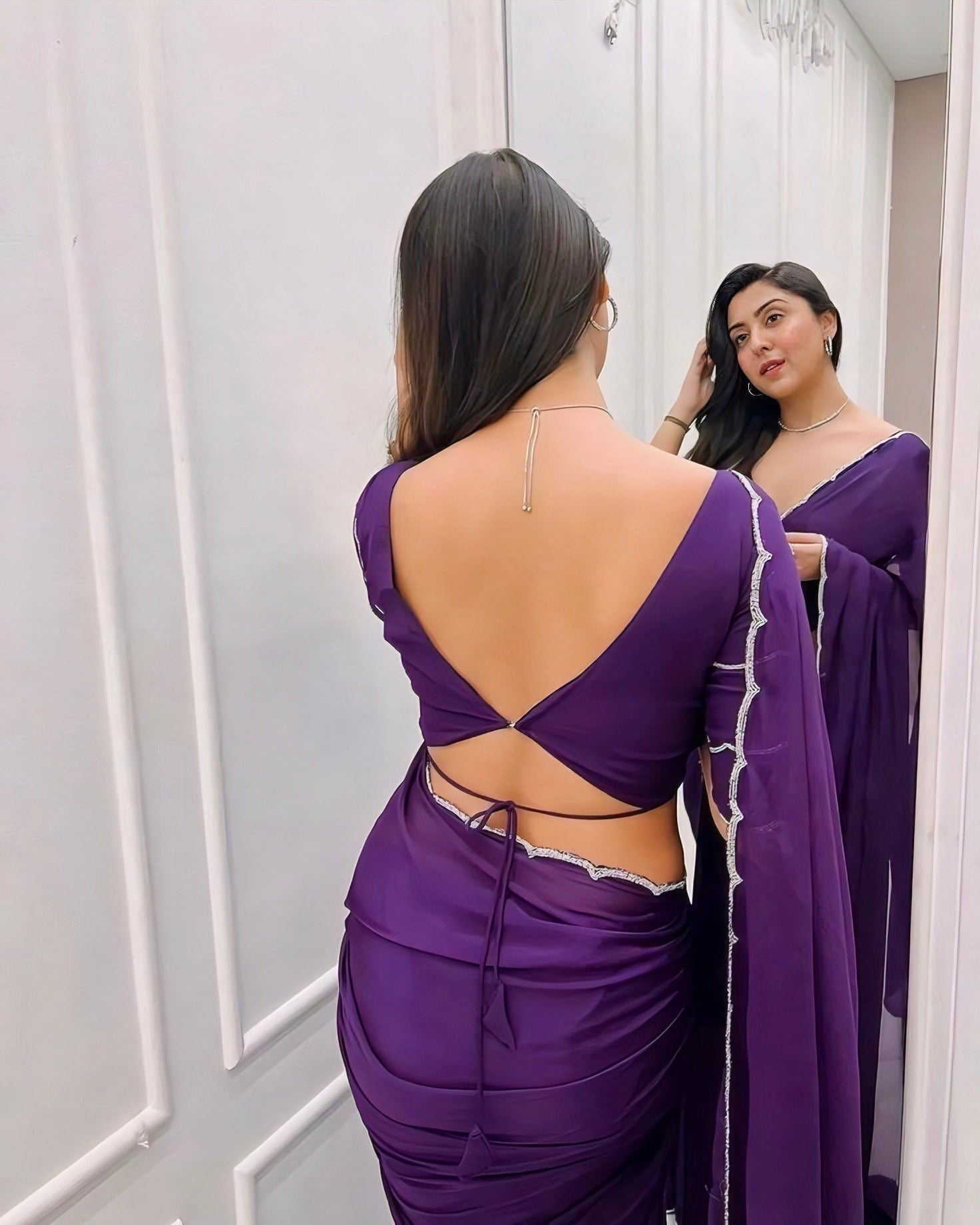 Purple deep V-back blouse with back-tie knot and silver edging – modern saree blouse design for parties.