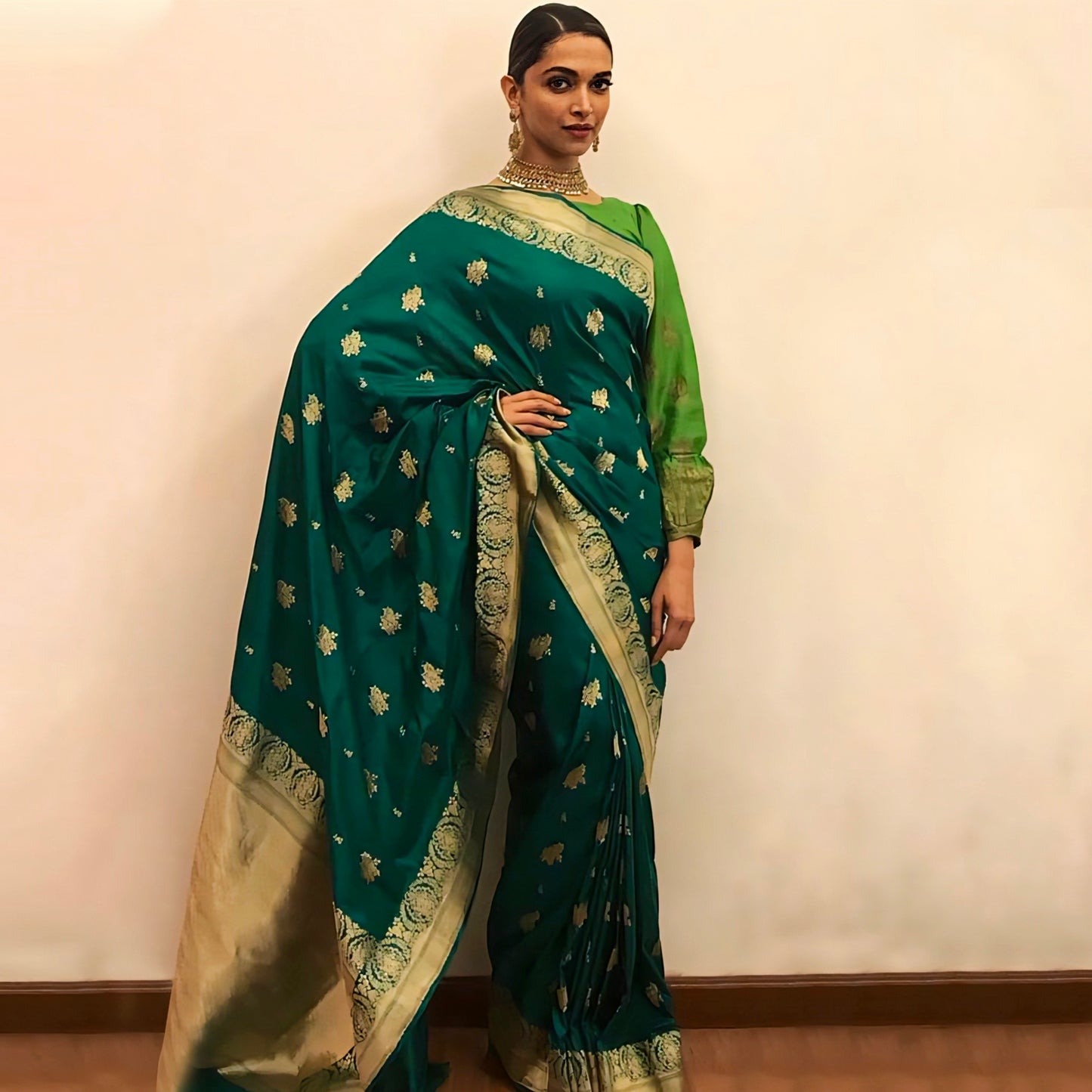 Emerald green Banarasi silk saree with golden zari border and motifs