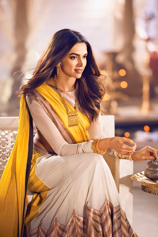 Woman wearing yellow and cream traditional saree with gold border