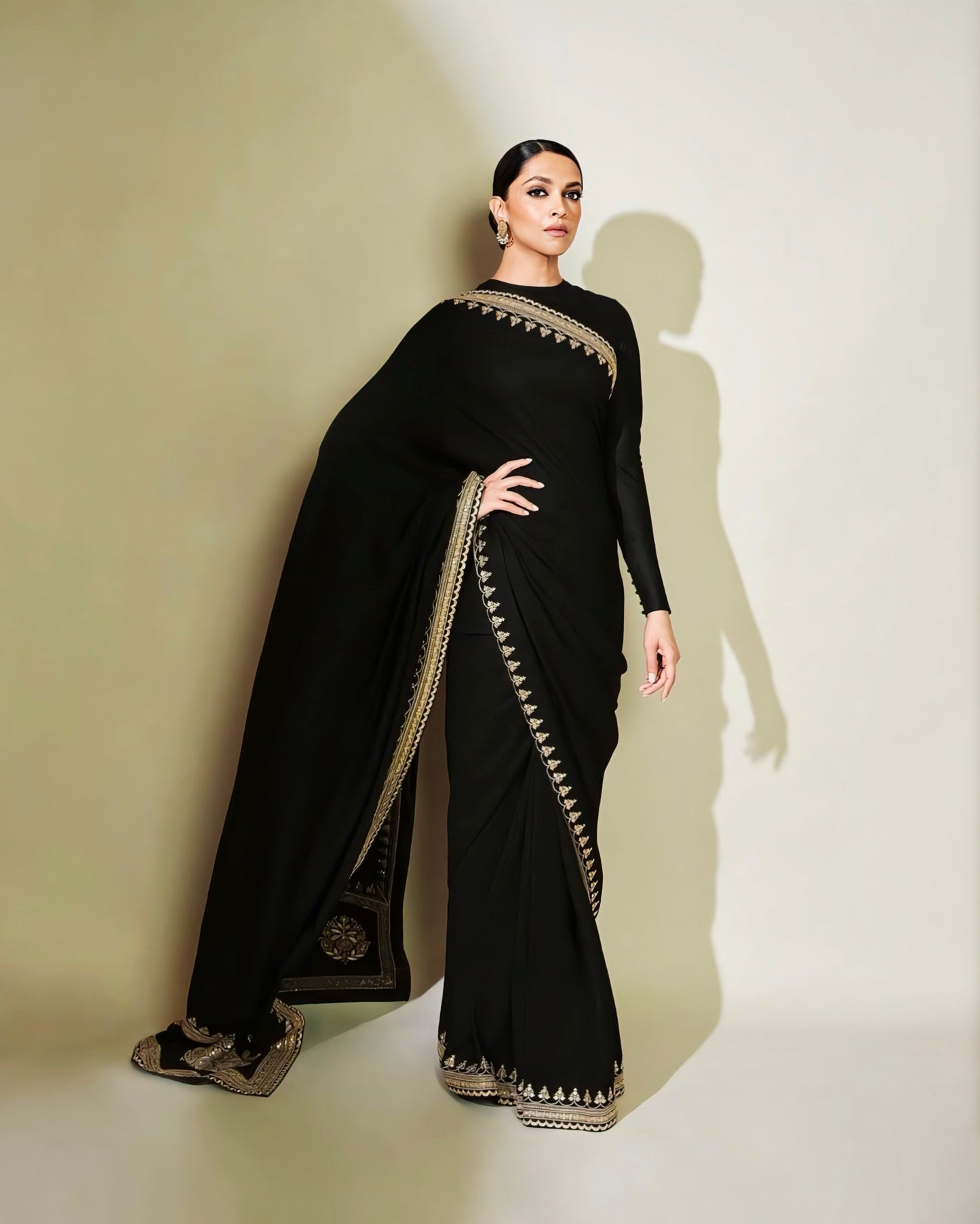 Deepika Padukone inspired black saree with golden embroidered border and full sleeve blouse