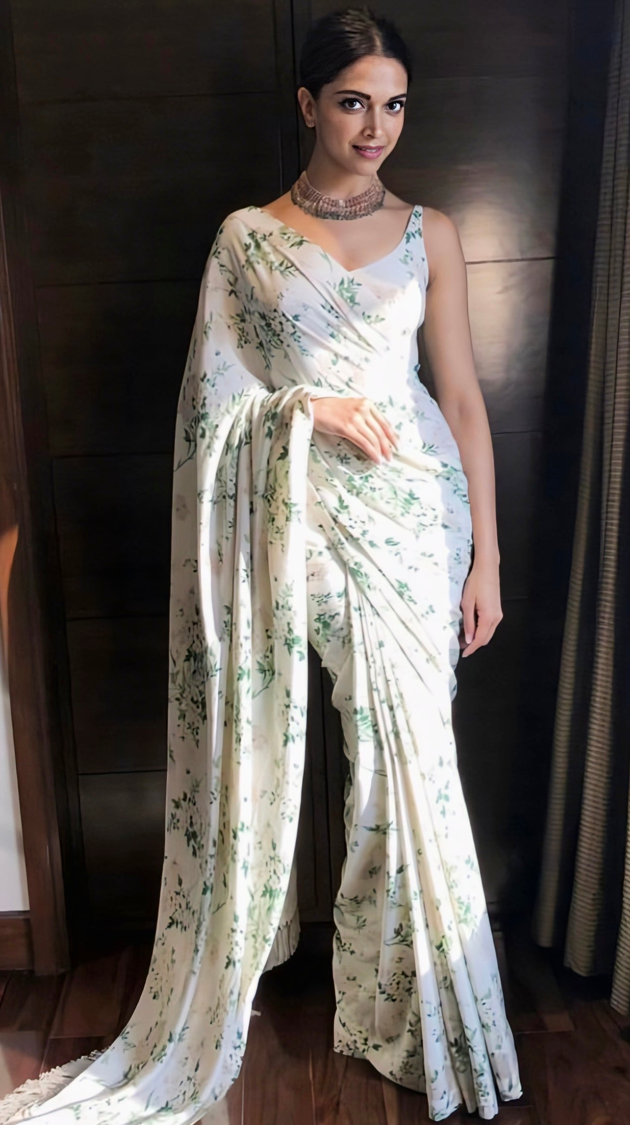 White floral saree with soft green print and sleeveless blouse
