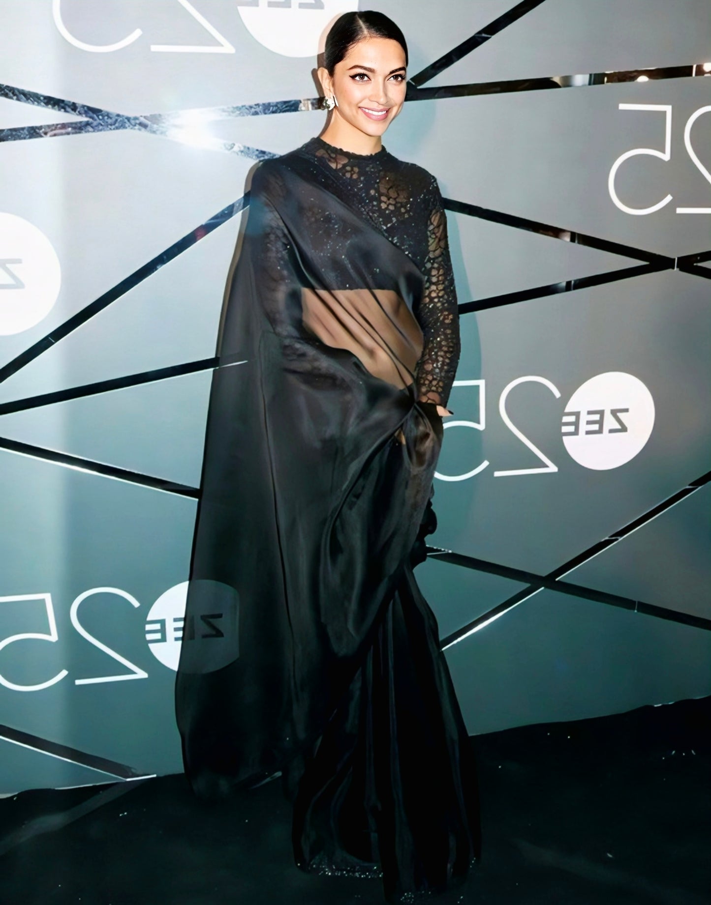 Black organza saree with sheer pallu and embroidered lace high-neck blouse