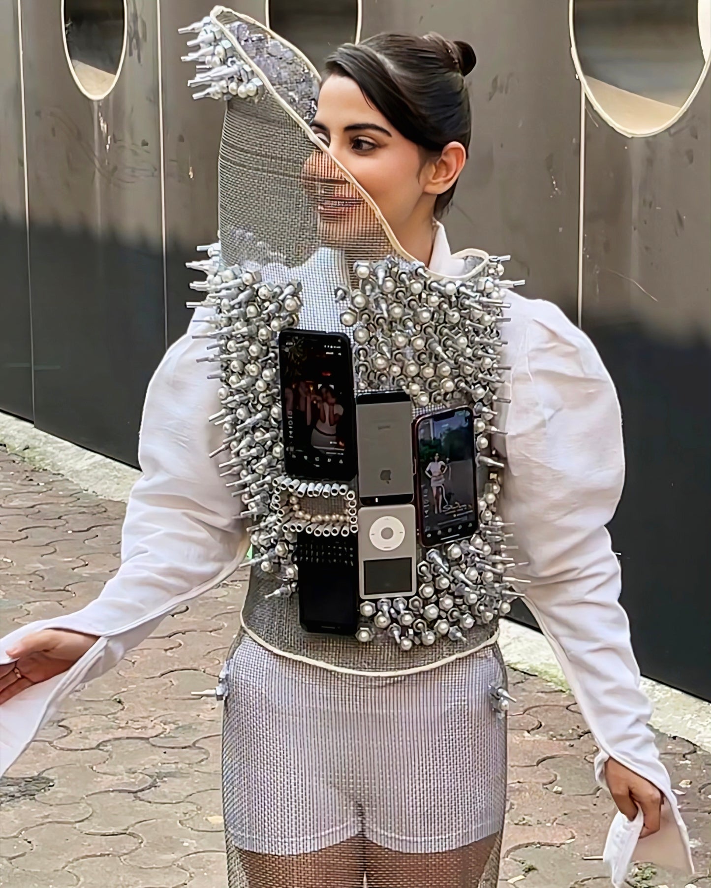 Urfi Javed steel mesh top adorned with nuts bolts and mobile devices paired with metallic heels futuristic couture look