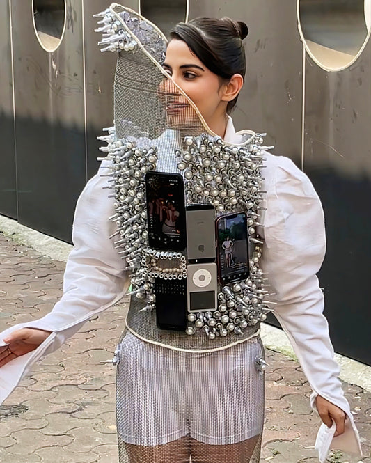 Urfi Javed steel mesh top adorned with nuts bolts and mobile devices paired with metallic heels futuristic couture look