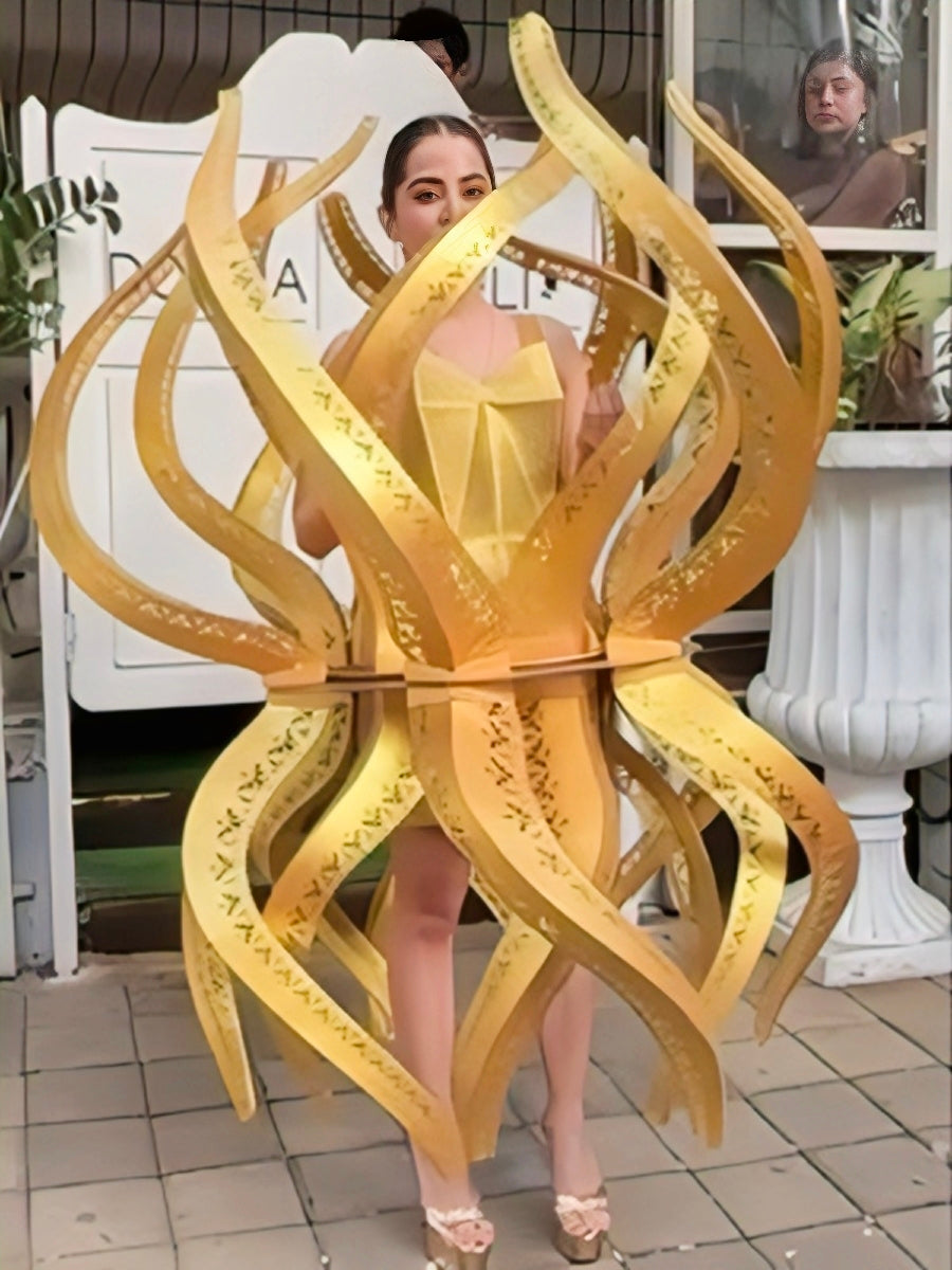 Urfi Javed golden sculptural flame outfit symbolizing Nari Shakti resilience and feminine power couture look