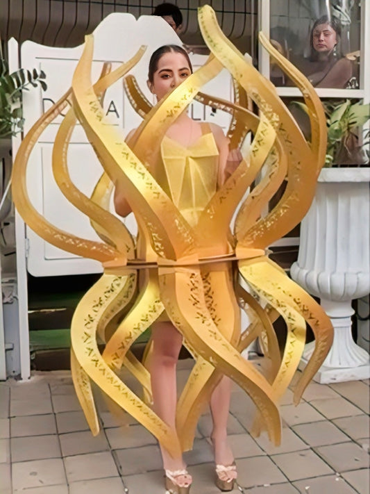 Urfi Javed golden sculptural flame outfit symbolizing Nari Shakti resilience and feminine power couture look