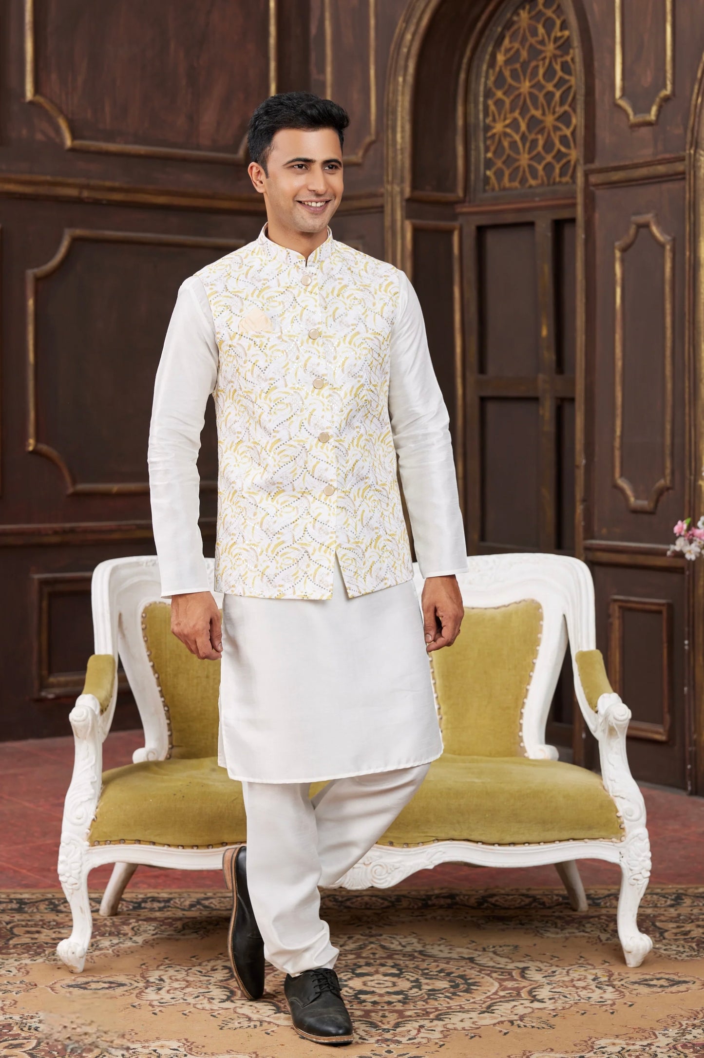 Man wearing stylish engagement white dress for men with embroidered Nehru jacket and kurta set, styled for a modern groom festive look