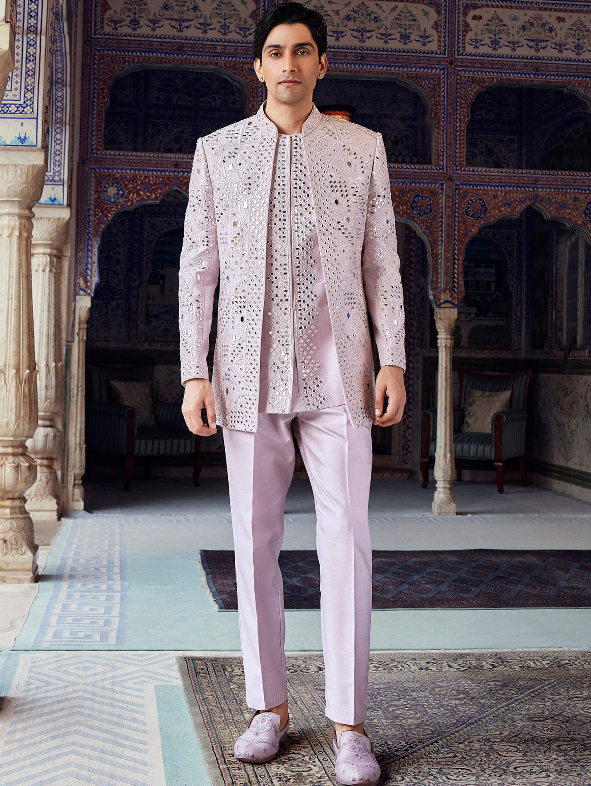 Man wearing engagement white dress for men inspired blush pink embroidered jacket set with mirror work, styled for a modern luxury groom look