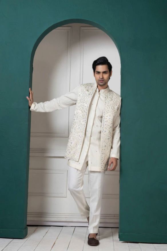 Engagement white dress for men featuring a white kurta set with embroidered jacket for a modern groom look