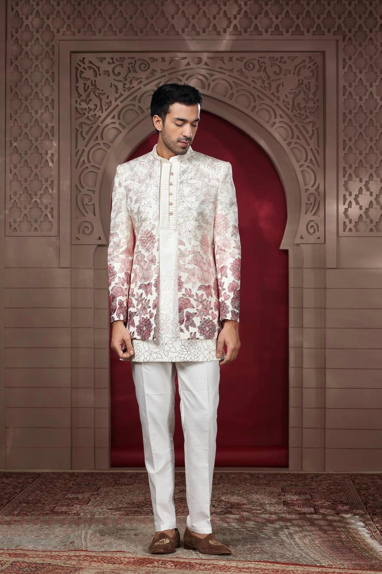 Engagement white dress for men with a floral printed jacket paired with a classic white kurta and trousers