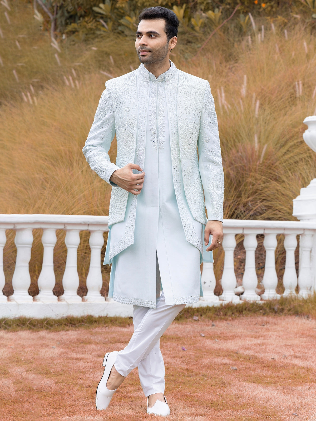 Engagement white dress for men with a hand-embroidered long jacket paired with a white kurta and trousers