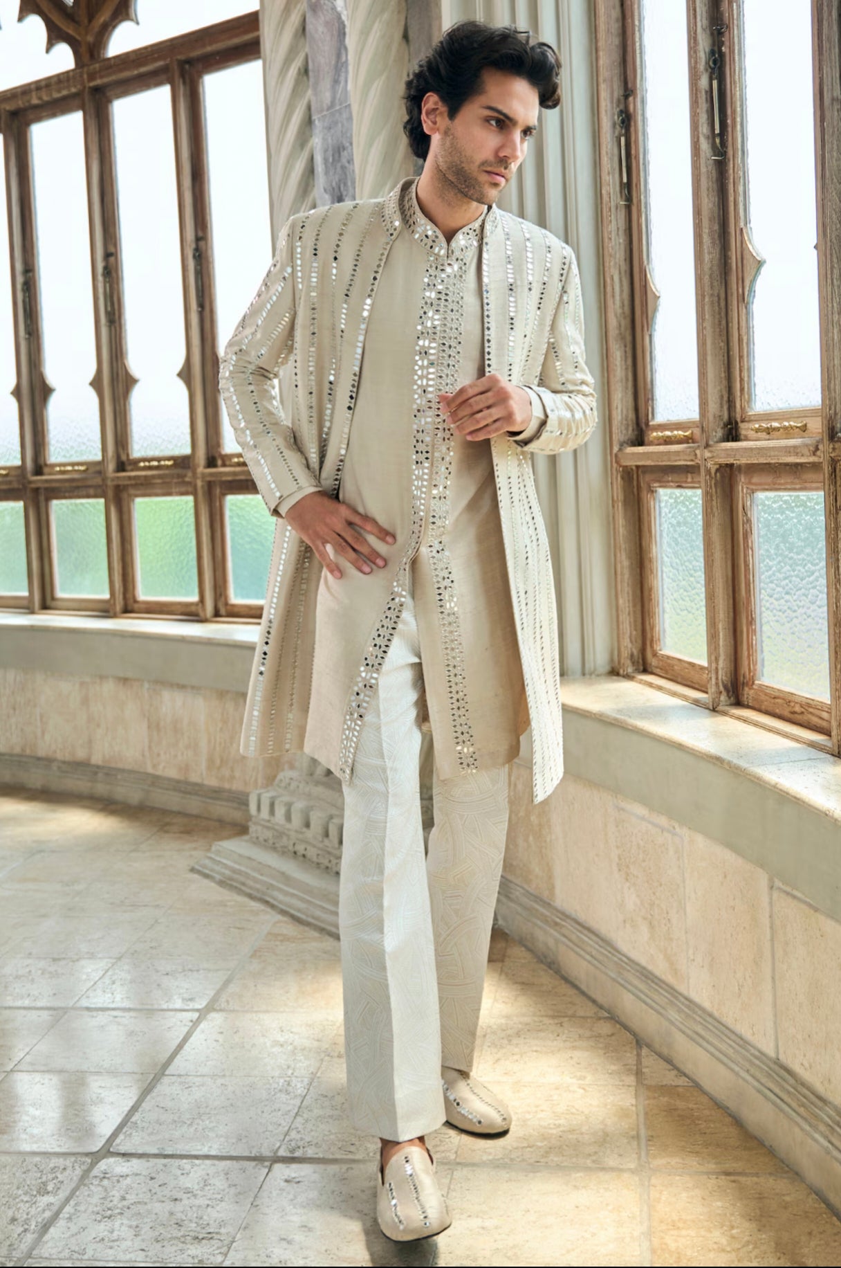 Engagement white dress for men with a mirror work long jacket paired with a white kurta and textured trousers