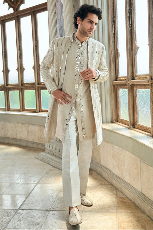 Engagement white dress for men with a mirror work long jacket paired with a white kurta and textured trousers
