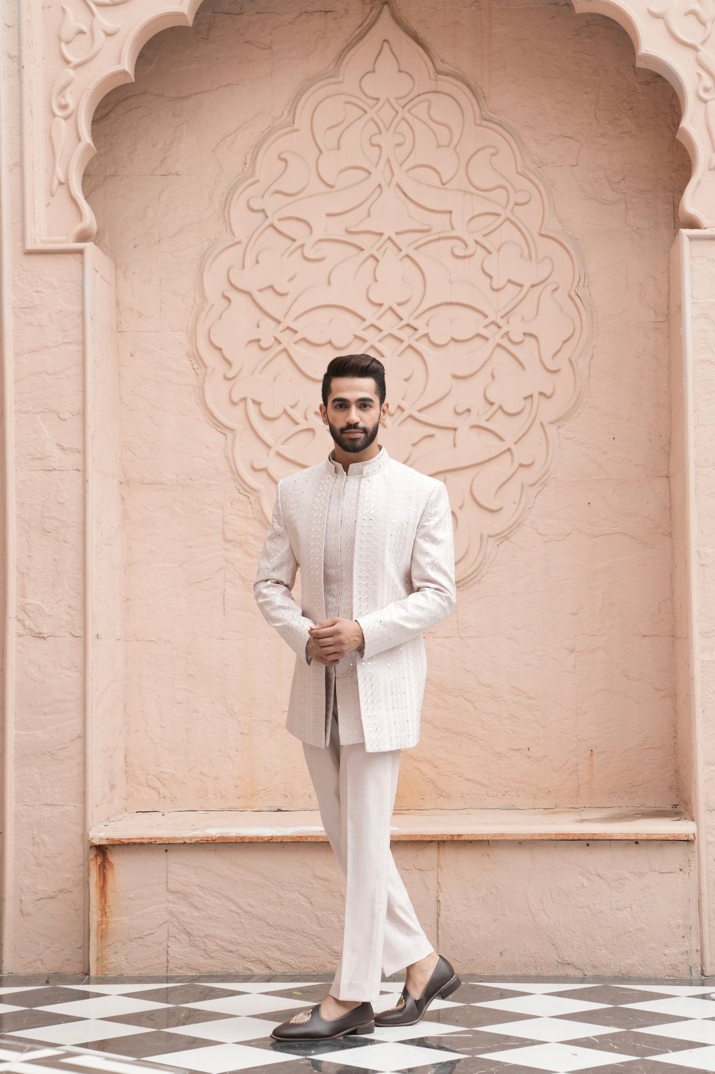 Engagement white dress for men with a textured designer jacket paired with a white kurta and tailored trousers
