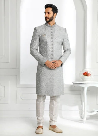Engagement white dress for men featuring silver grey embroidered sherwani with white churidar