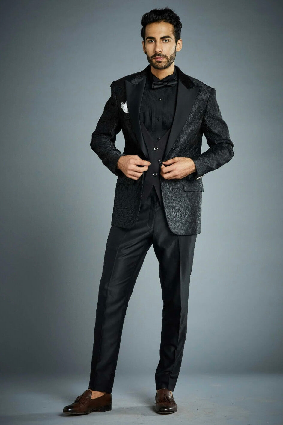 Black textured tuxedo suit for men with satin peak lapel and waistcoat