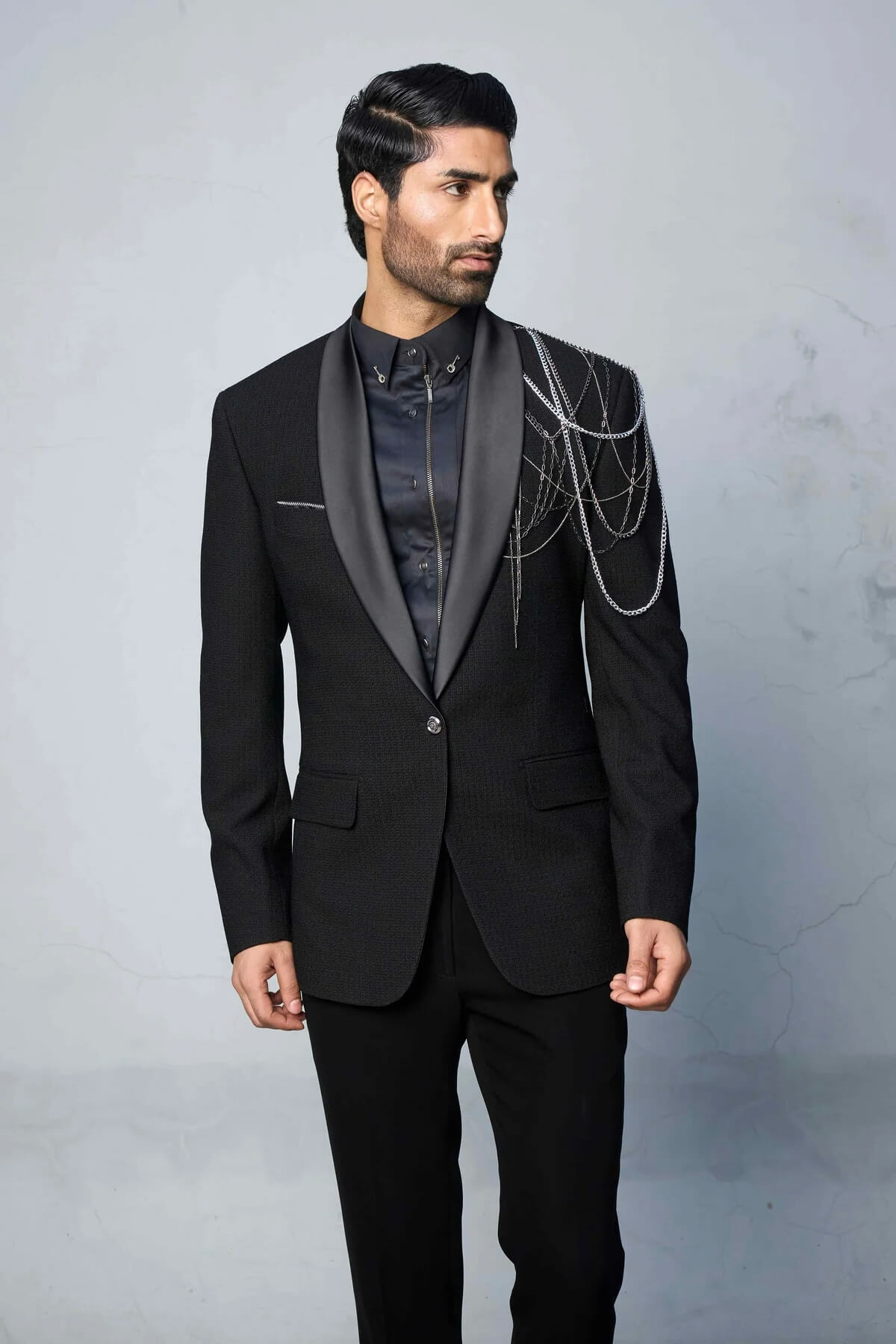 Black textured tuxedo suit for men with satin peak lapel and waistcoat