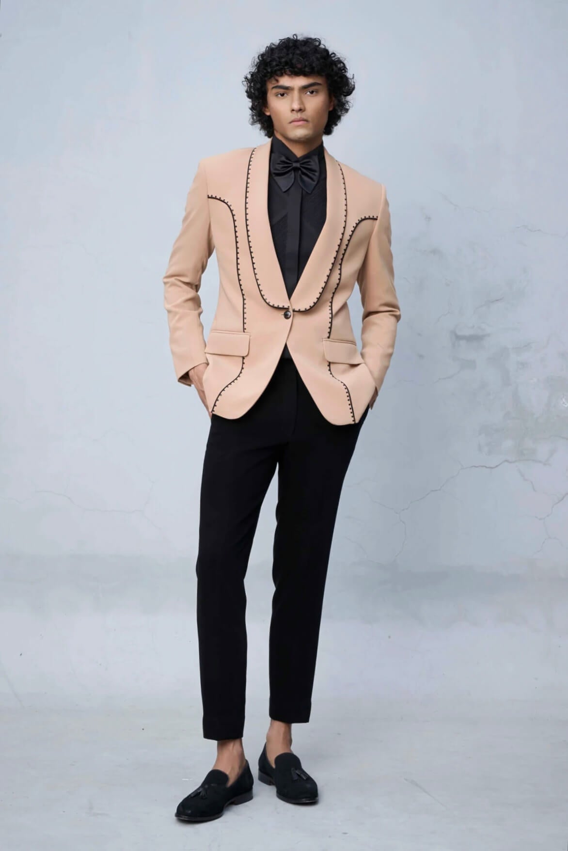 Peach designer tuxedo suit for men with black lapel and contrast stitch detailing