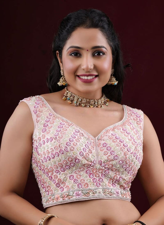 Cream princess cut sleeveless blouse with blush pink floral embroidery and V-neck design