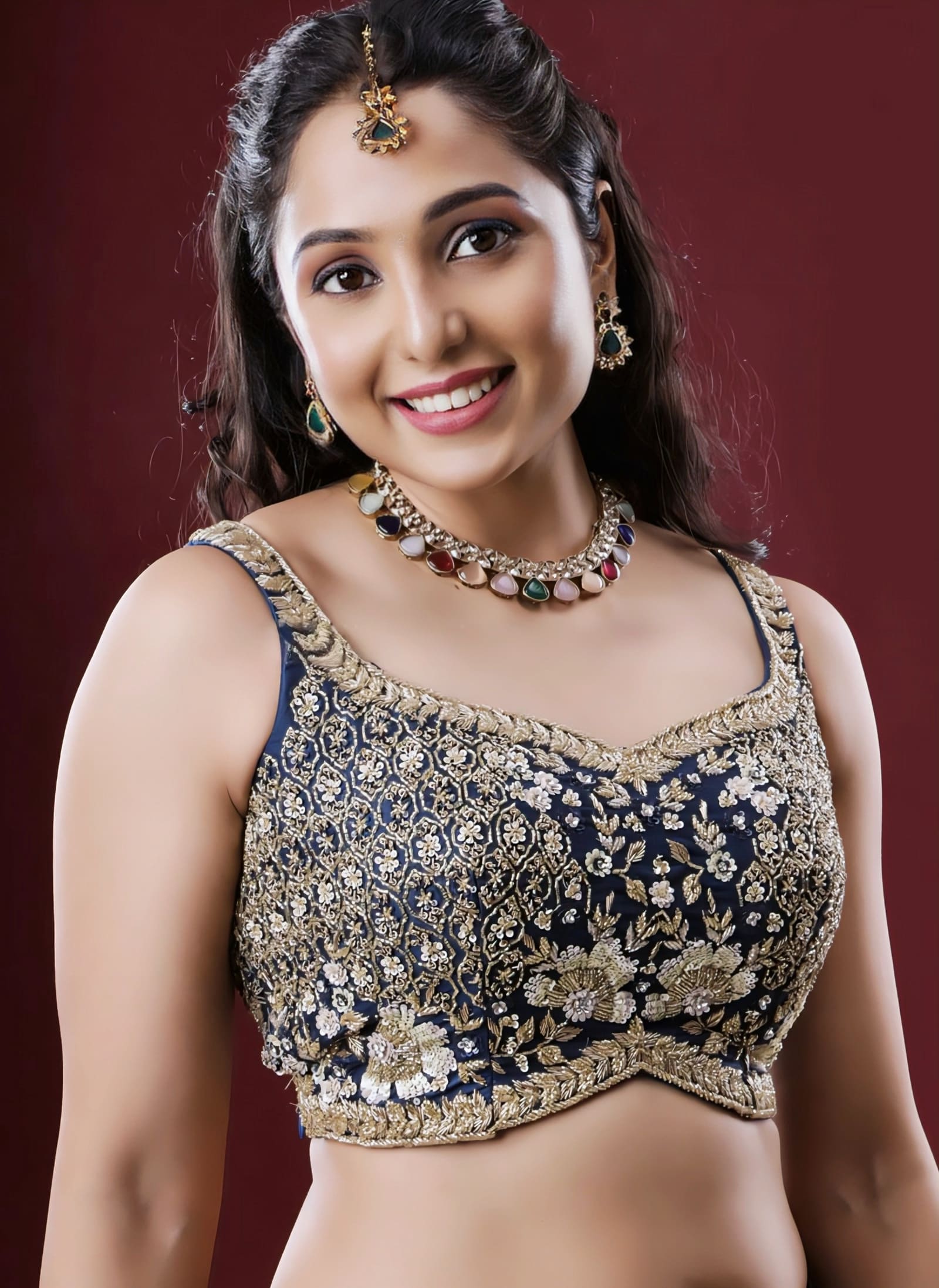 Navy blue princess cut sleeveless blouse with heavy gold embroidery and sweetheart neckline