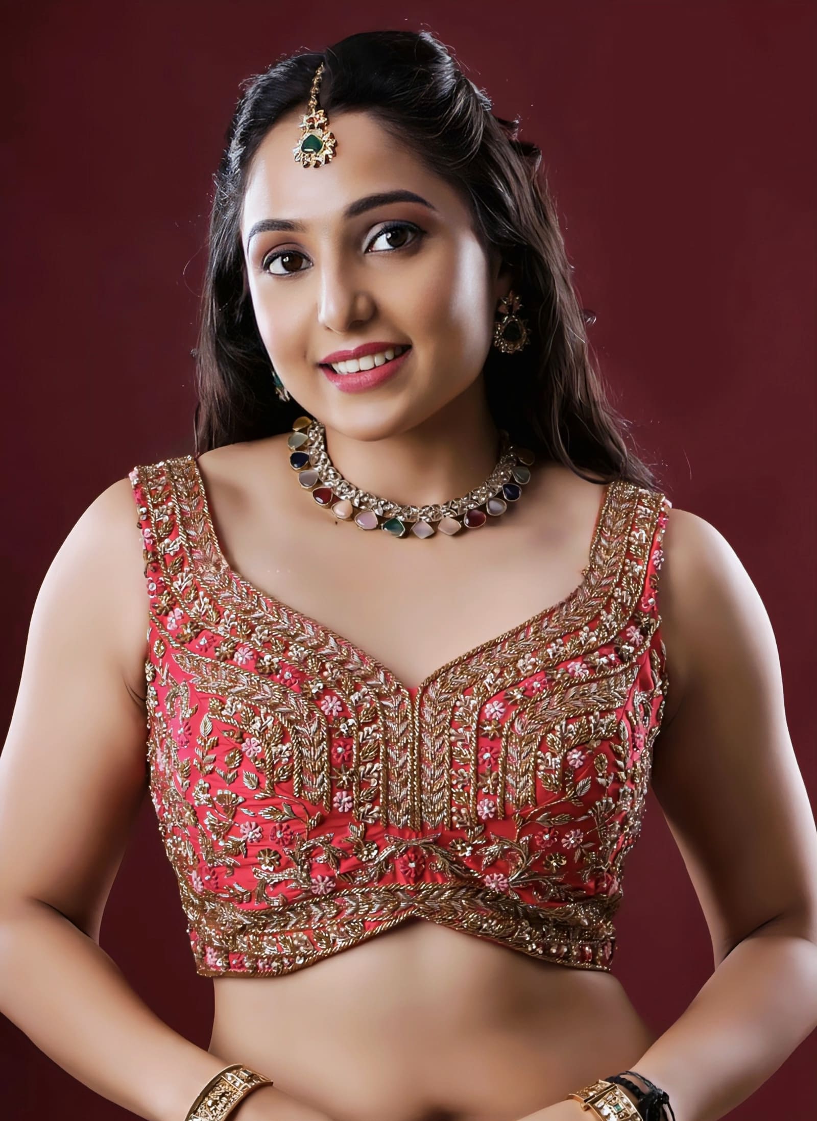 Red princess cut sleeveless blouse with heavy gold embroidery and V-neck design