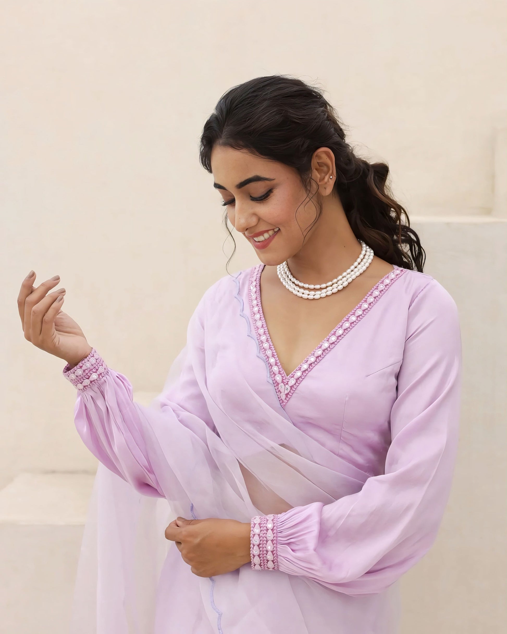 Lavender V neck blouse with pearl embellished borders and sheer full sleeves styled for elegant festive wear