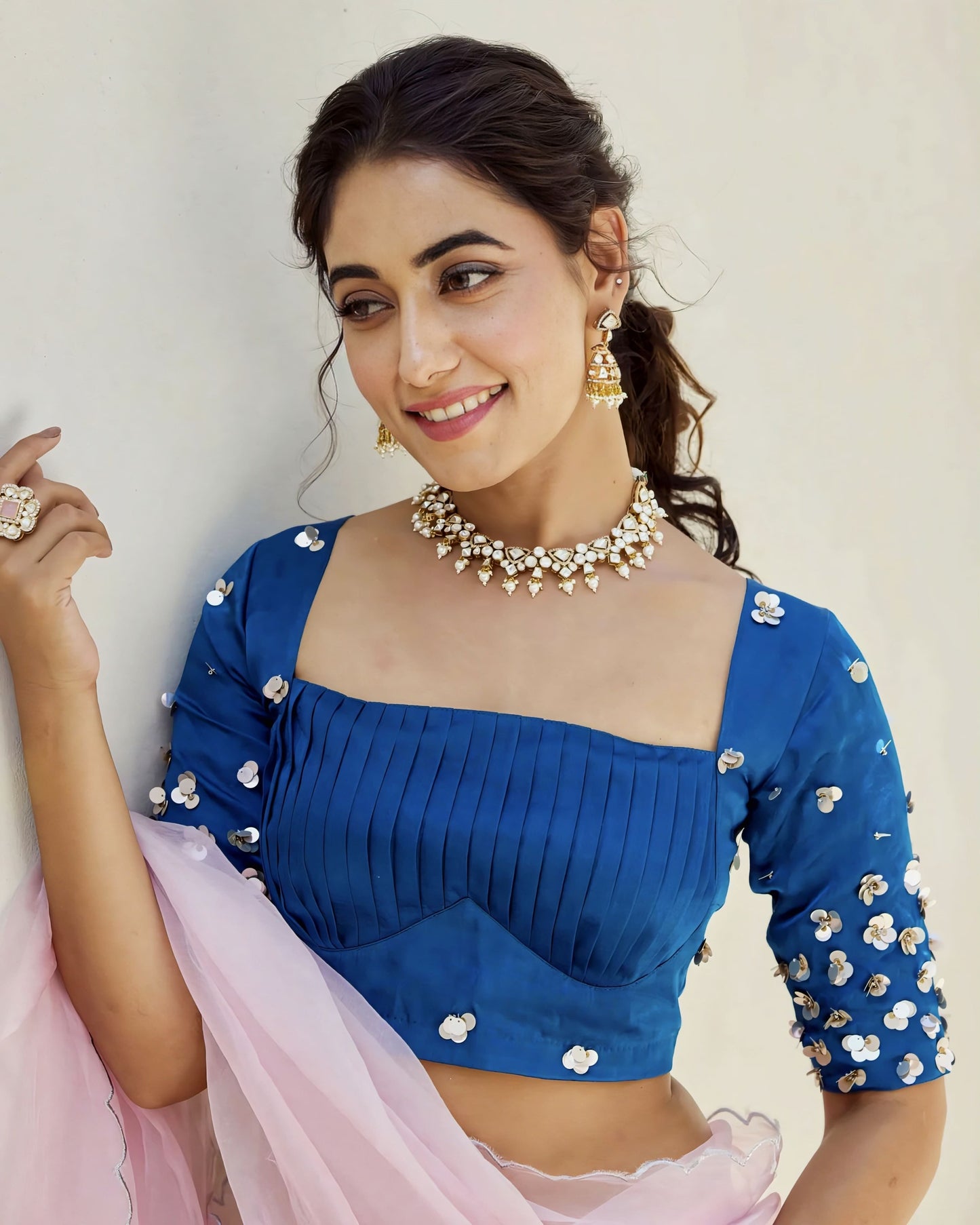 Royal blue princess cut blouse with square neckline and sequin embellished three quarter sleeves styled with pastel pink saree