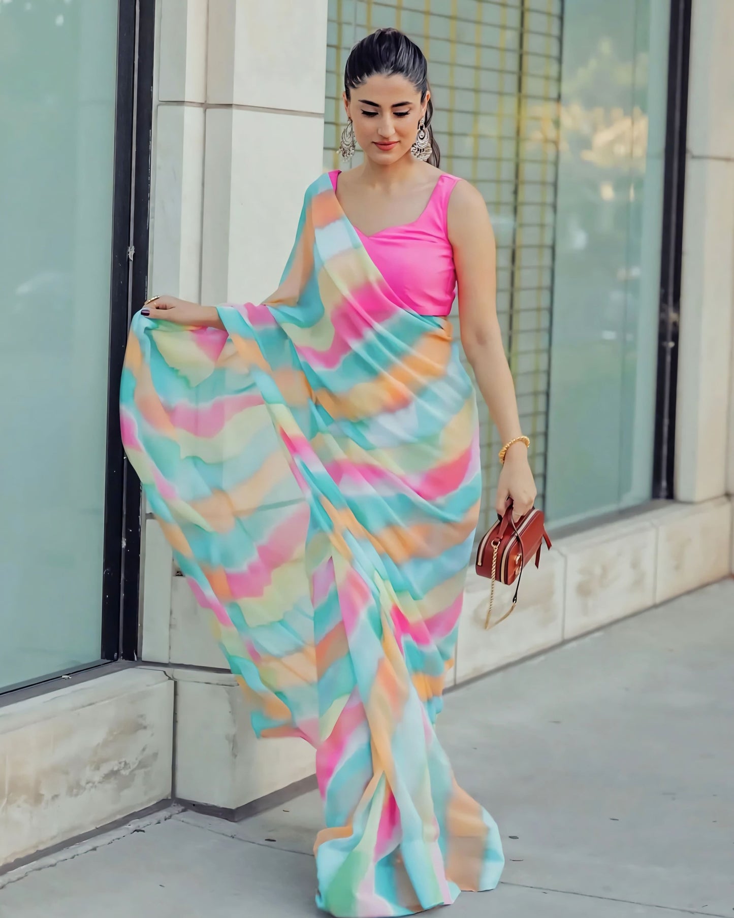 Hot pink sleeveless princess cut blouse paired with multicolor printed saree