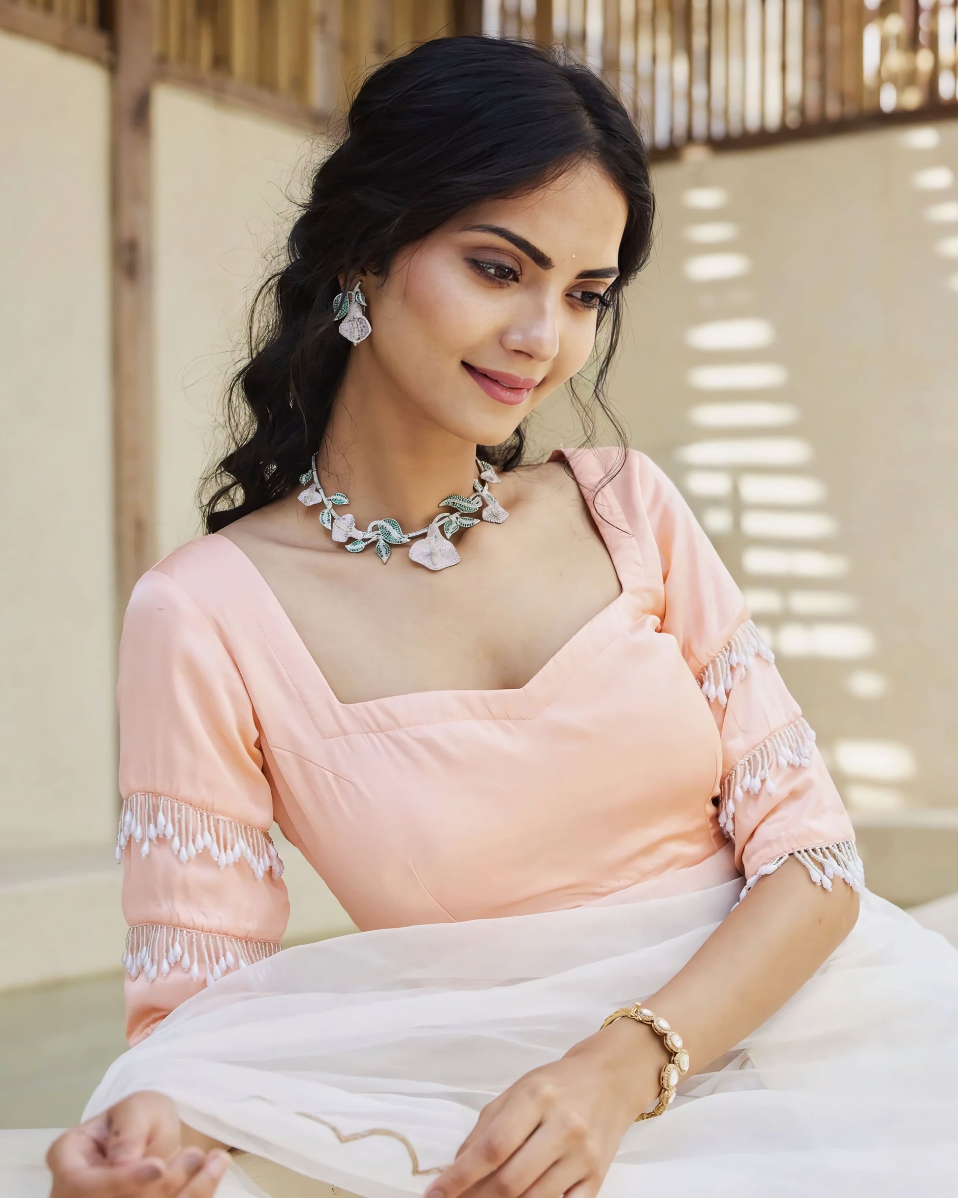 Peach princess cut blouse with fringe sleeve detailing paired with white saree