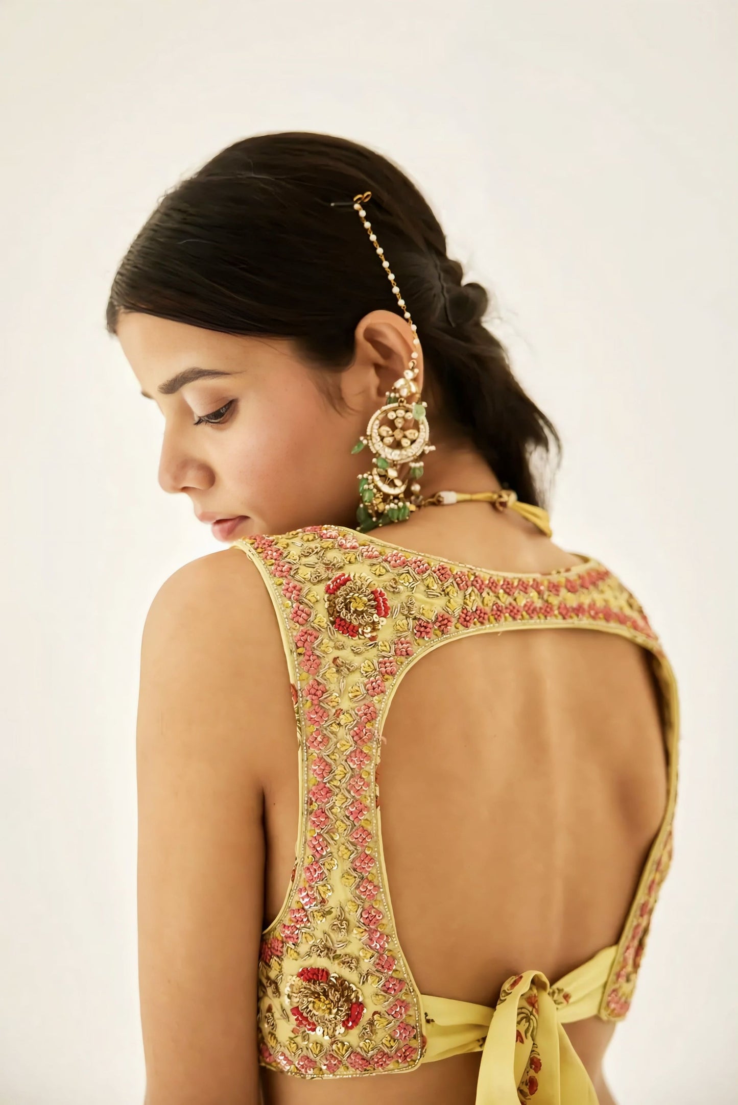Yellow embroidered backless designer blouse with floral handwork and tie-up back