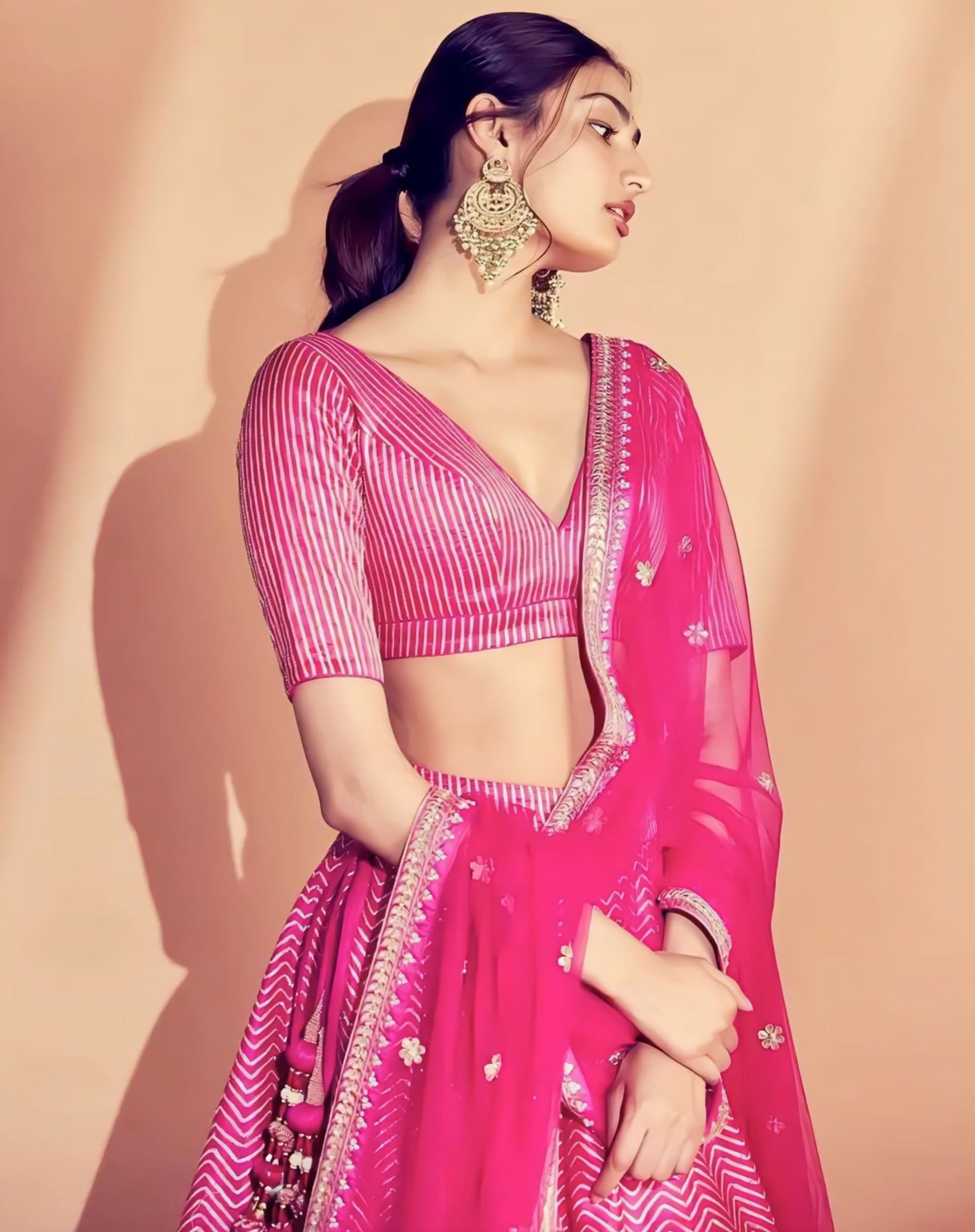 Pink striped designer blouse with deep V-neckline and half sleeves for lehenga